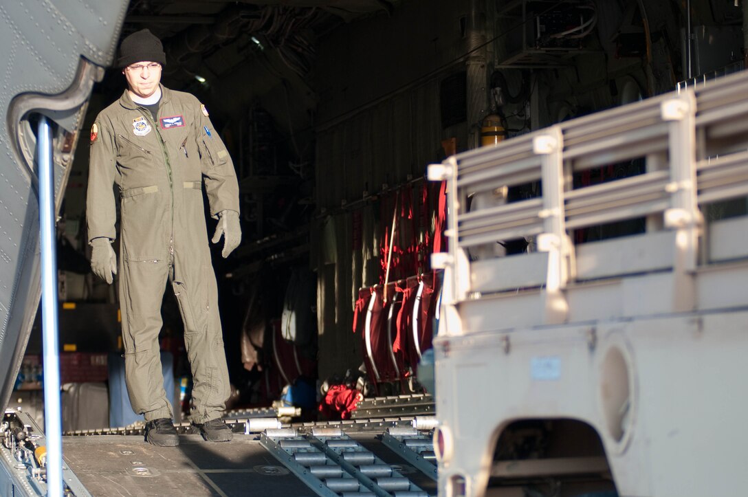 Tech. Sgt. Joshua Perrigo  with the 139th Airlift Wing, Mo. Air National Guard, looks on as a humvee is loaded into a 139th AW, C-130 at Fort Hood, Tx, as they prepare  for another relief mission to Port-Au-Prince, Haiti, February 9, 2010. Haiti was devastated by an earthquake on January 12 and the 139th AW started flying relief missions on February 3.(U.S. Air Force photo by Master Sgt. Shannon Bond/Released)
