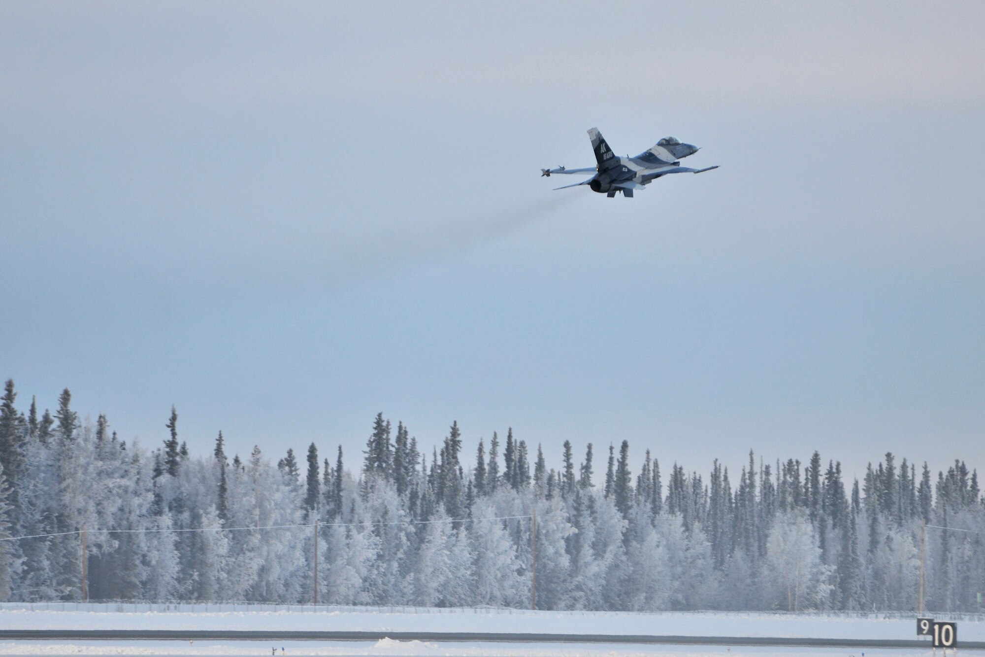 Brigadier General Mark W. Graper launches from the runway in an F-16 Fighting Falcon Aggressor during his last flight as commander of the 354th Fighter Wing Feb. 05, 2010, Eielson Air Force Base, Alaska. General Graper will relinquish command to Colonel James Post III Feb. 12. (U.S. Air Force photo/Staff Sgt. Christopher Boitz)