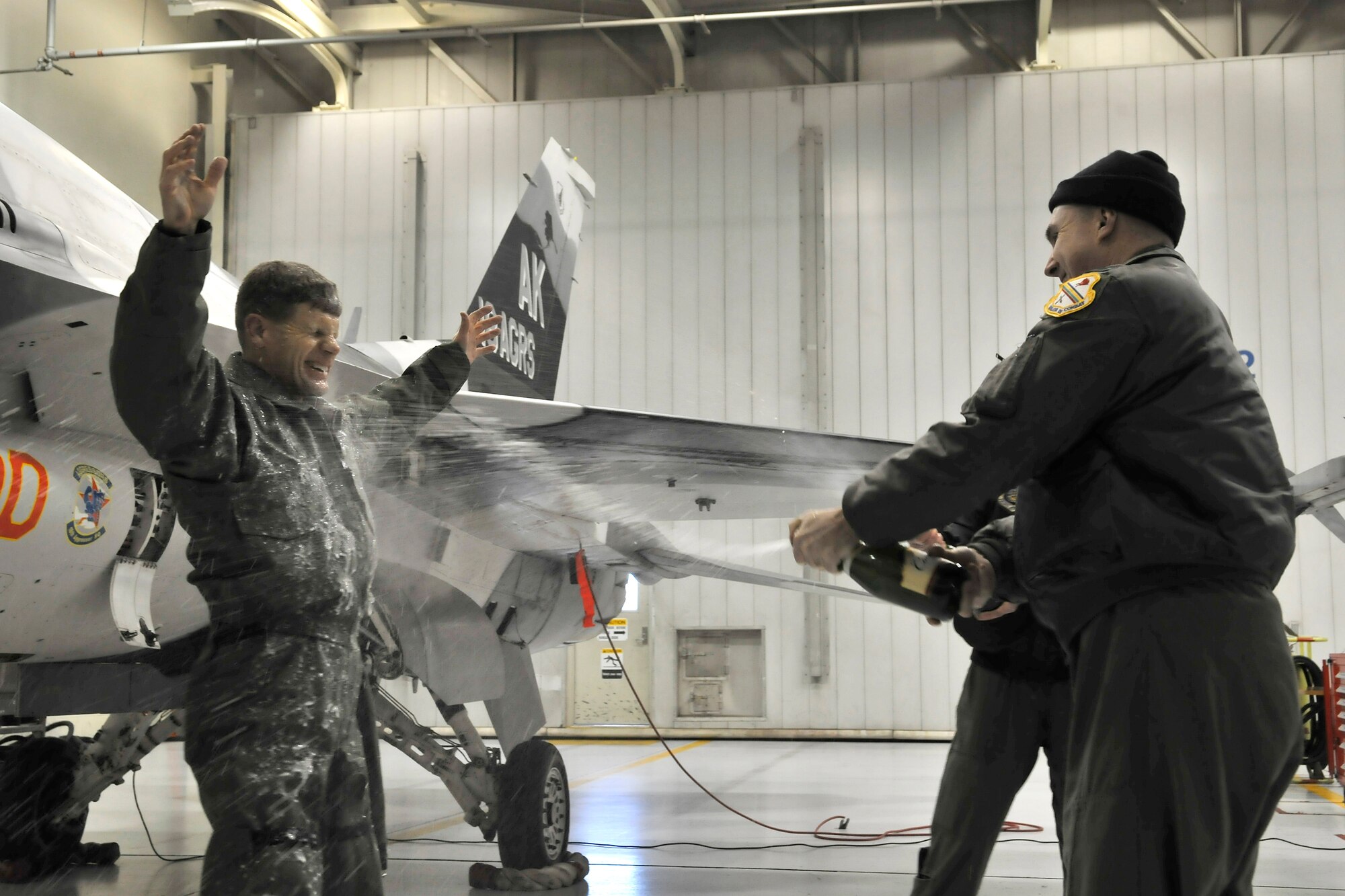 Brigadier General Mark W. Graper receives a champagne bath from his fellow Iceman after his last flight as commander of the 354th Fighter Wing Feb. 05, 2010, Eielson Air Force Base, Alaska. General Graper will relinquish command to Colonel James Post III Feb. 12. (U.S. Air Force photo/Staff Sgt. Christopher Boitz)