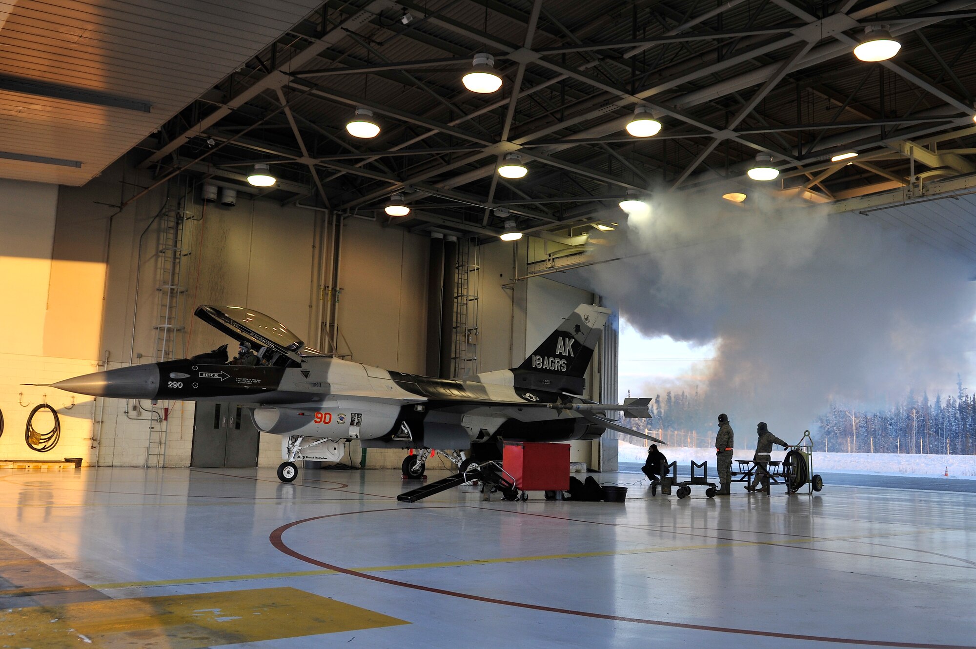 Crew chiefs from the 18th Aircraft Maintenance Squadron prepare to launch an F-16 Fighting Falcon Aggressor flown by Brigadier General Mark W. Graper during his last flight as commander of the 354th Fighter Wing Feb. 05, 2010, Eielson Air Force Base, Alaska. General Graper will relinquish command to Colonel James Post III Feb. 12. (U.S. Air Force photo/Staff Sgt. Christopher Boitz)