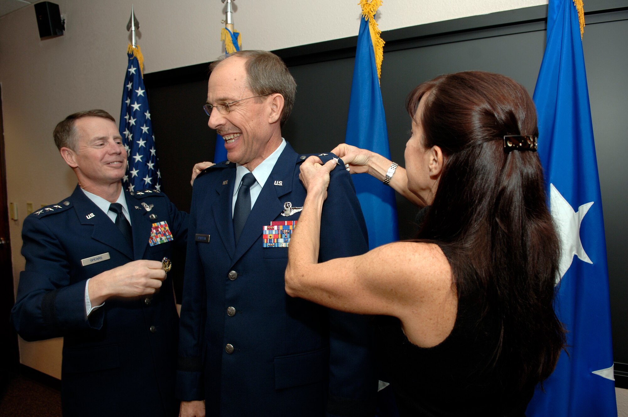 DAVIS-MONTHAN AIR FORCE BASE, Ariz. -- Lt. Gen. Glenn Spears (left), 12th Air Force (Air Forces Southern) commander, pins a second star to the right epaulet of Maj. Gen. Jon Shasteen (middle), while General Shasteen's wife Susan (right) pinned the new rank to the left. General Shasteen is the mobilization assistant to the commander and was promoted to major general during a ceremony here Feb. 5. (U.S. Air Force photo/Tech. Sgt. Eric Petosky)