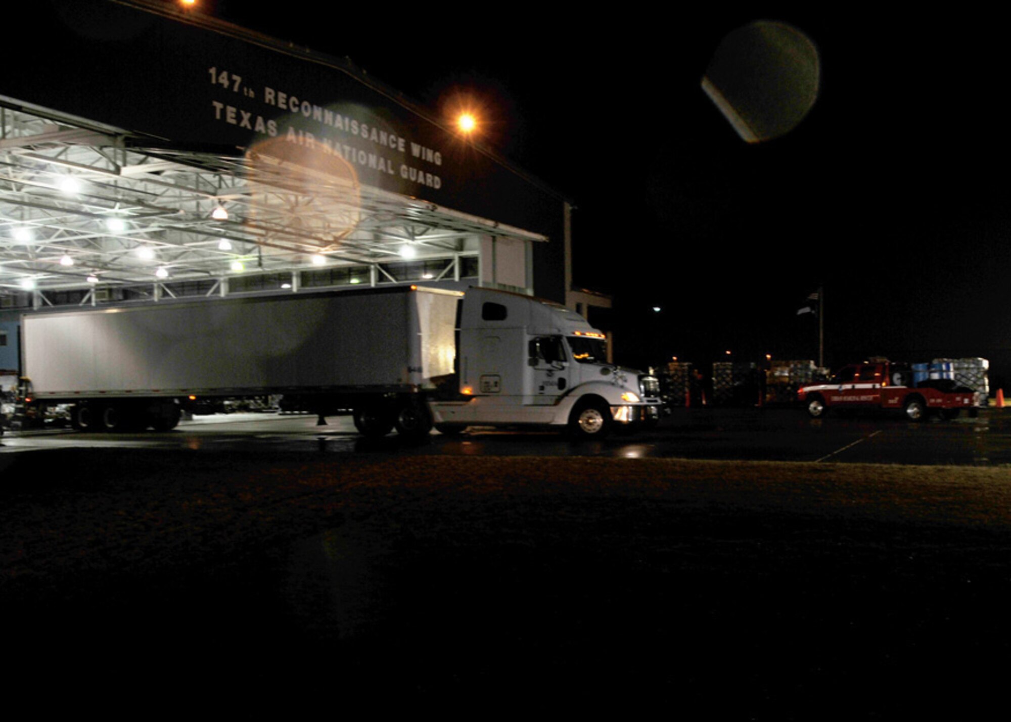 A transport truck is being unloaded at the 147 Reconnaissance Wing hangar.  The truck is carrying equipment belonging to Texas Task Force One for possible deployment to Haiti.  147 RW photo by: MSgt Dale Hanson