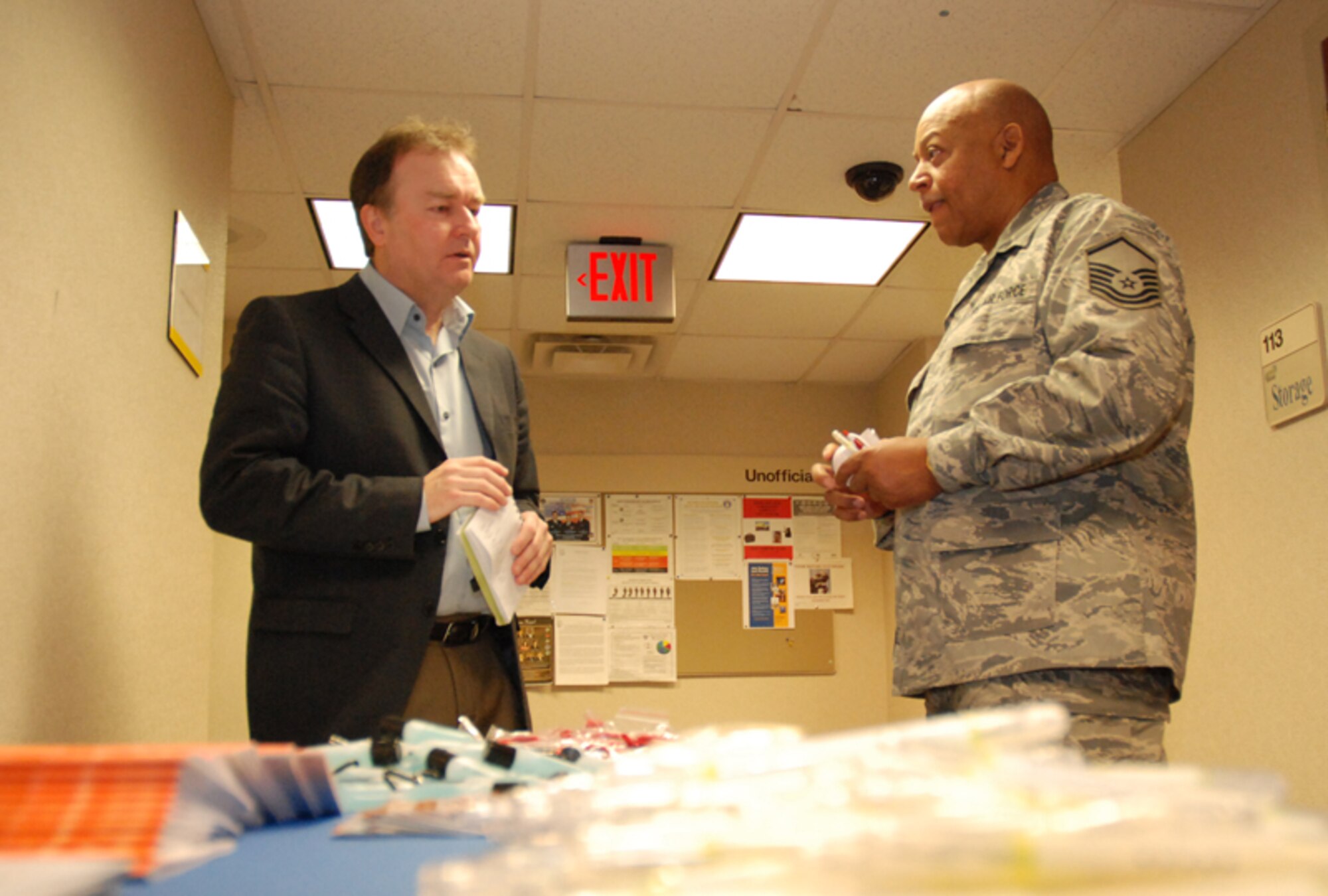 Master Sgt.  Jerry A. Durr, air tactical operations center supervisor, 80th Aerial Port Squadron, weighs insurance options with Tony Kennedy, tricare representative at the Yellow Ribbon Reintegration Program at the 22nd Air Force Conference Center here Feb. 7. The goal of the program is to prepare them for mobilization, sustain them during mobilization, and reintegrate Airmen with their families, communities, and employers upon return. (U.S. Air Force photo/Senior Airman Shaun Shenk)