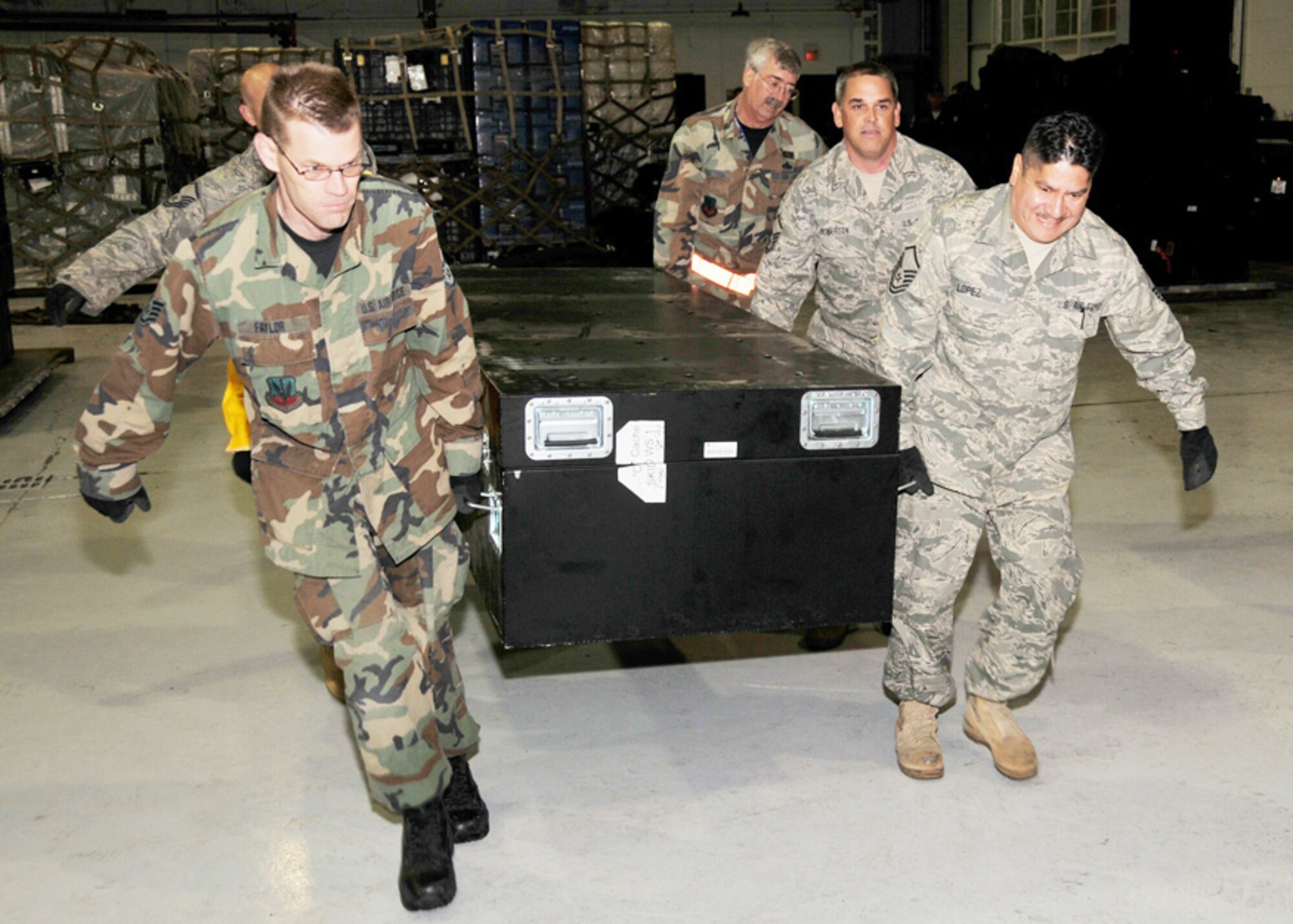 147th Reconnaissance Wing members move equipment belonging toTexas Task Force One to an air transport pallet at Ellington Field Joint Reserve Base Houston Texas 14 January 2010.  147 RW photo by: MSgt Dale Hanson