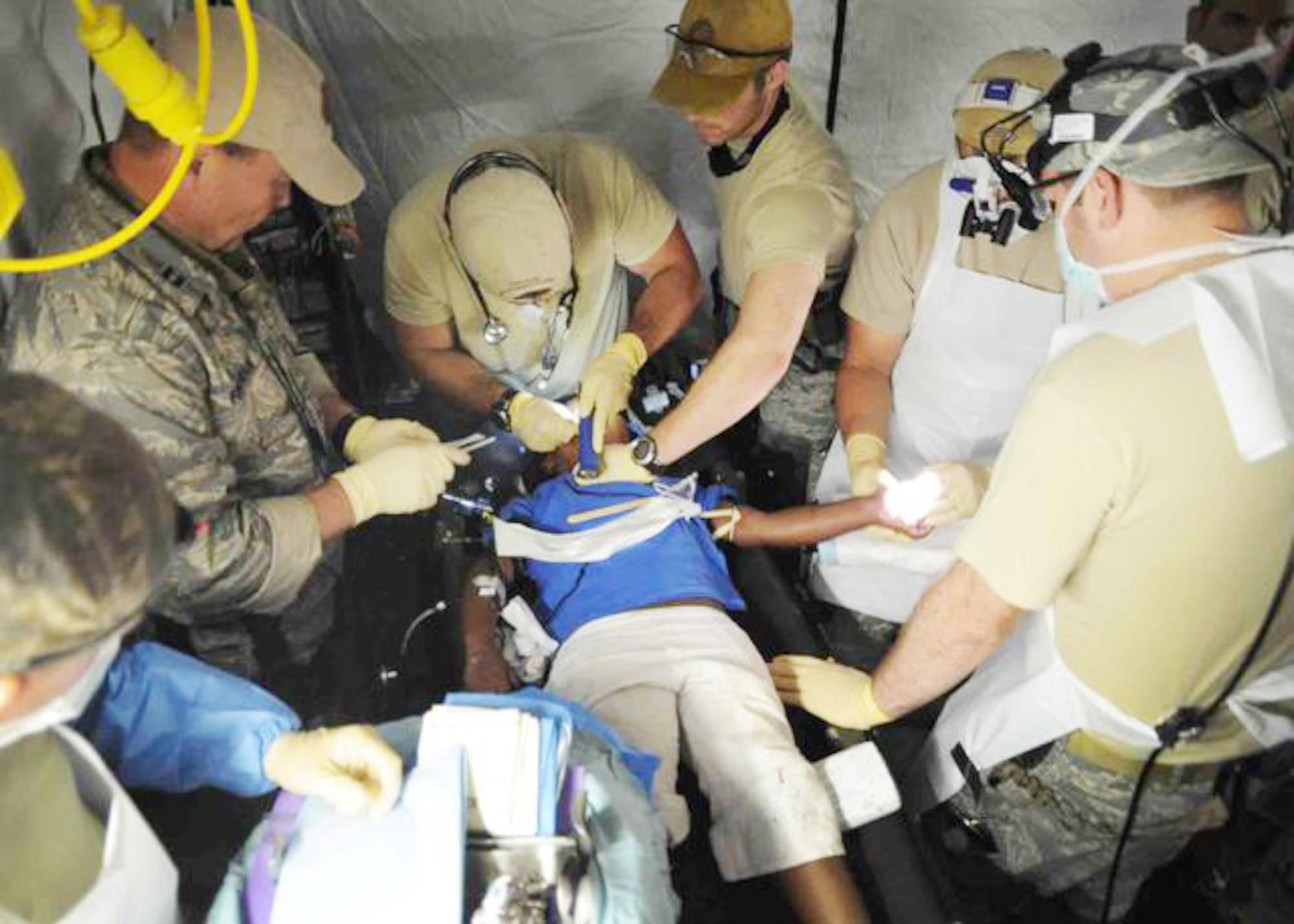 Airmen with the 1st Special Operations Support Squadron offer medical assistance to a Haitian girl Jan. 16, 2010, at the Toussaint L'Ouverture International Airport in Port-au-Prince, Haiti. (U.S. Navy photo/Petty Officer 2nd Class Justin Stumberg)