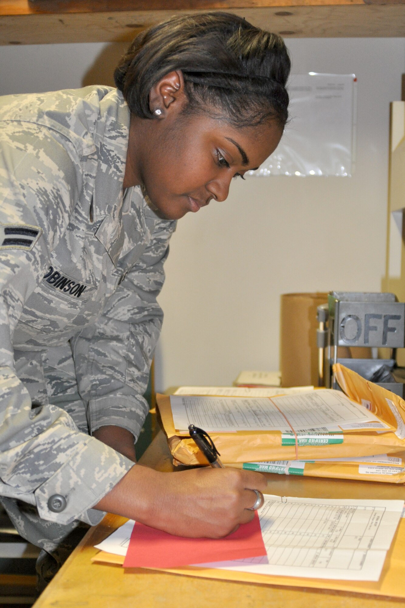 Airman 1st Class Kirstie Robinson, a client support administrator for the 917th Wing Communication Flight on Barksdale Air Force Base, La., completes paperwork needed for mail deliveries to the 917th WG headquarters building. Airman Robinson, originally from Monroe, La., has been in the United States Air Force for almost a year, joining in order to be a part of an organization that makes a difference and to add structure to her life. She recognizes Master Sgt. Rodney Jones as the person who has influenced her most throughout her military career because he is fair and hardworking, all that a senior non-commissioned officer should be. He shows the Air Force’s core values in his everyday actions. In fact, having the opportunity to meet and learn from people like Sergeant Jones is what Airman Robinson enjoys most about her job here. When she isn’t working, Airman Robinson enjoys visiting local restaurants with friends. (U.S. Air Force Photo/Senior Airman Crystal Marie Jordan)