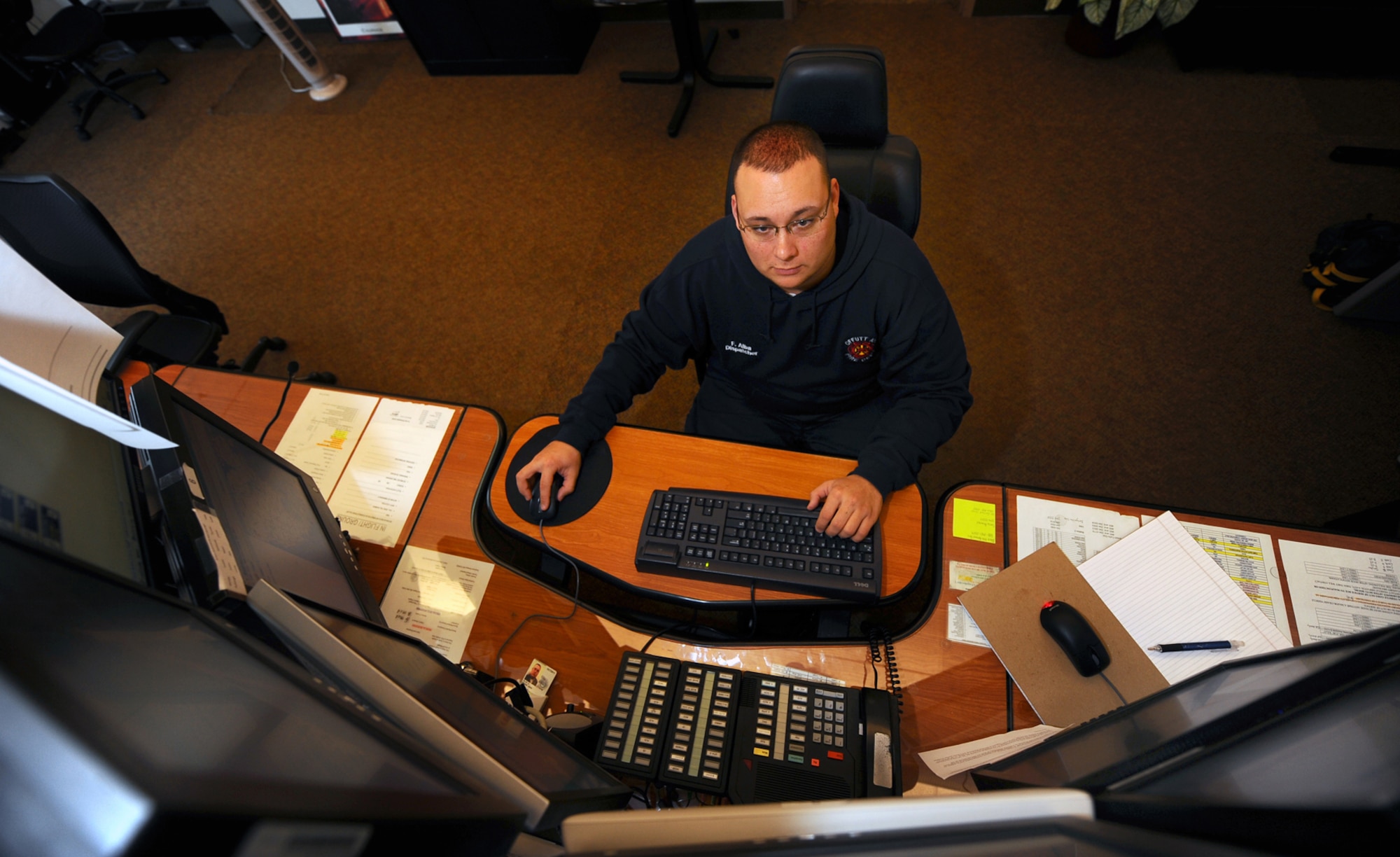 OFFUTT AIR FORCE BASE, Neb. - Frank Alba, a dispatcher for the 55th Civil Engineering Squadron Fire Department, monitors cameras and mans the emergency phone lines in the fire station.  Fire department dispatchers are knowledgeable in all areas regarding fire fighting and are essential to ensuring firefighters are dispatched in a timely manner. U.S. Air Force photo by Josh Plueger
