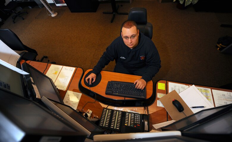 OFFUTT AIR FORCE BASE, Neb. - Frank Alba, a dispatcher for the 55th Civil Engineering Squadron Fire Department, monitors cameras and mans the emergency phone lines in the fire station.  Fire department dispatchers are knowledgeable in all areas regarding fire fighting and are essential to ensuring firefighters are dispatched in a timely manner. U.S. Air Force photo by Josh Plueger
