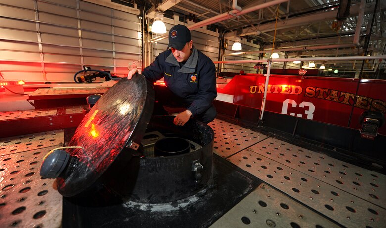 OFFUTT AIR FORCE BASE, Neb.- Derek Larson, a firefighter and driver engineer for the 55th Civil Engineering Squadron Fire Department, checks a fire truck's water and foam tanks as part of daily operational checks inside the Offutt Fire Station here Feb. 5. The two separate tanks containing 1,500 gallons of water and 500 gallons of foam combine with one another when dispersed through a hose which gives firefighters about two- and-a-half minutes of continuous fire fighting ability. U.S. Air Force photo by Josh Plueger


