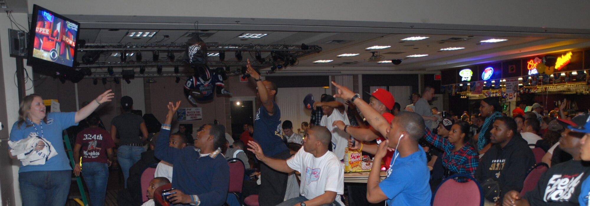 GOODFELLOW AIR FORCE BASE, Texas -- The crowd tries to catch free gear during the Super Bowl party hosted by the Event Center, Feb. 7, 2010. More than 200 Goodfellow AFB members attended this event. (U.S. Air Force photo/Staff Sgt. Laura R. McFarlane)
