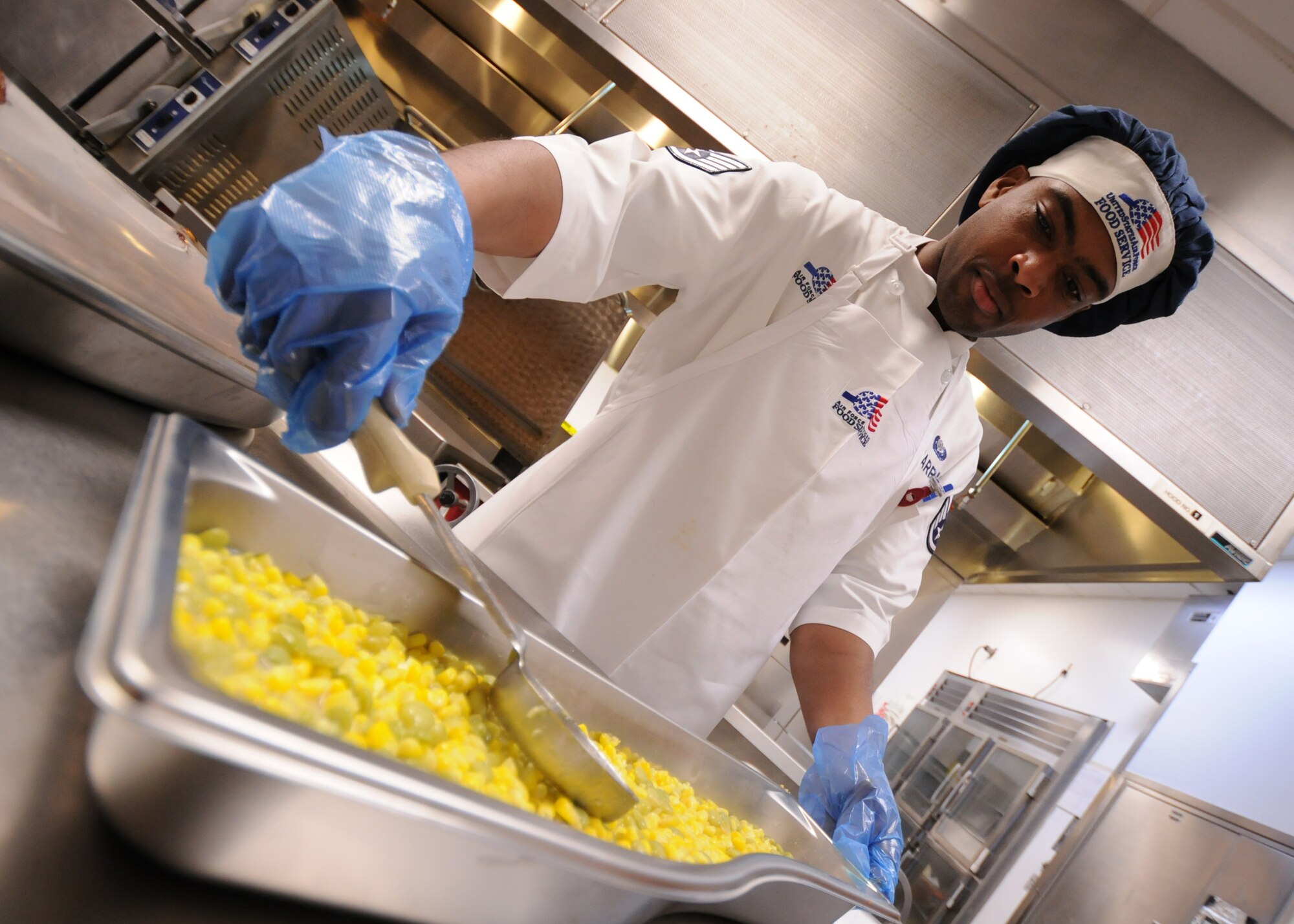 Staff Sgt. Damien Harris, 96th Force Support Squadron, prepares succotash prior to lunch at Eglin's "The Breeze" dining facility, Feb. 9.  The "Breeze" serves approximately 580 personnel at lunch and 1,500 throughout the day between breakfast and dinner.  (U.S. Air Force photo/Airman 1st Class Anthony Jennings.)