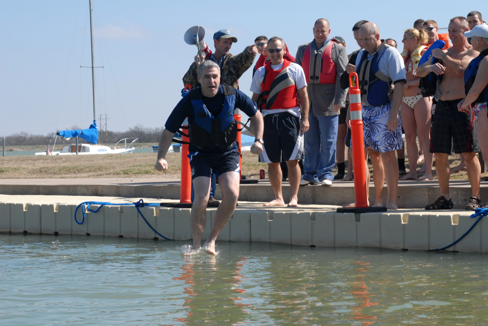 SAN ANGELO, Texas -- Col. Thomas Geary, 17th Training Wing commander, jumps into Lake Nasworthy initiating the annual Polar Bear Swim at the Goodfellow Air Force Base Recreation Camp, Feb. 6, 2010. More than 180 Goodfellow AFB members participated in this event. Water temperature was 33 degrees. (U.S. Air Force photo/Staff Sgt. Laura R. McFarlane)
