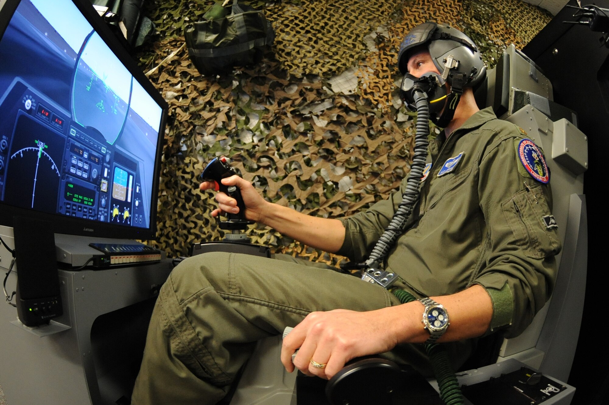 WHITEMAN AIR FORCE BASE, Mo. - Maj. Alex Jernigan, Detachment 12 commander, gives the simulator full-throttle for take-off as he begins hypoxia recognition training,  Feb. 8, 2010. The training is used as a refresher course in recognizing individual signs of hypoxia, a deficiency of oxygen to the body that is sufficient enough to cause an impairment of function. (U.S. Air Force photo/Airman 1st Class Carlin Leslie)(Released)