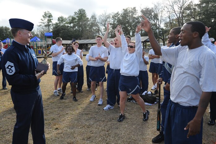 U.S. Air Force Chief Master Sgt. Mike Ivey presents the professional enhancement center enlisted olympics award to the Airman Leadership School after they defeated the First Term Airmen Center during a fitness challenge at the base picnic grounds here Feb. 1, 2010. More than 40 students and instructors from ALS and FTAC teamed up to hold the games as a fun fitness challenge. Chief Ivey is the 628th Air Wing command chief. (U.S. Air Force photo/James M. Bowman)