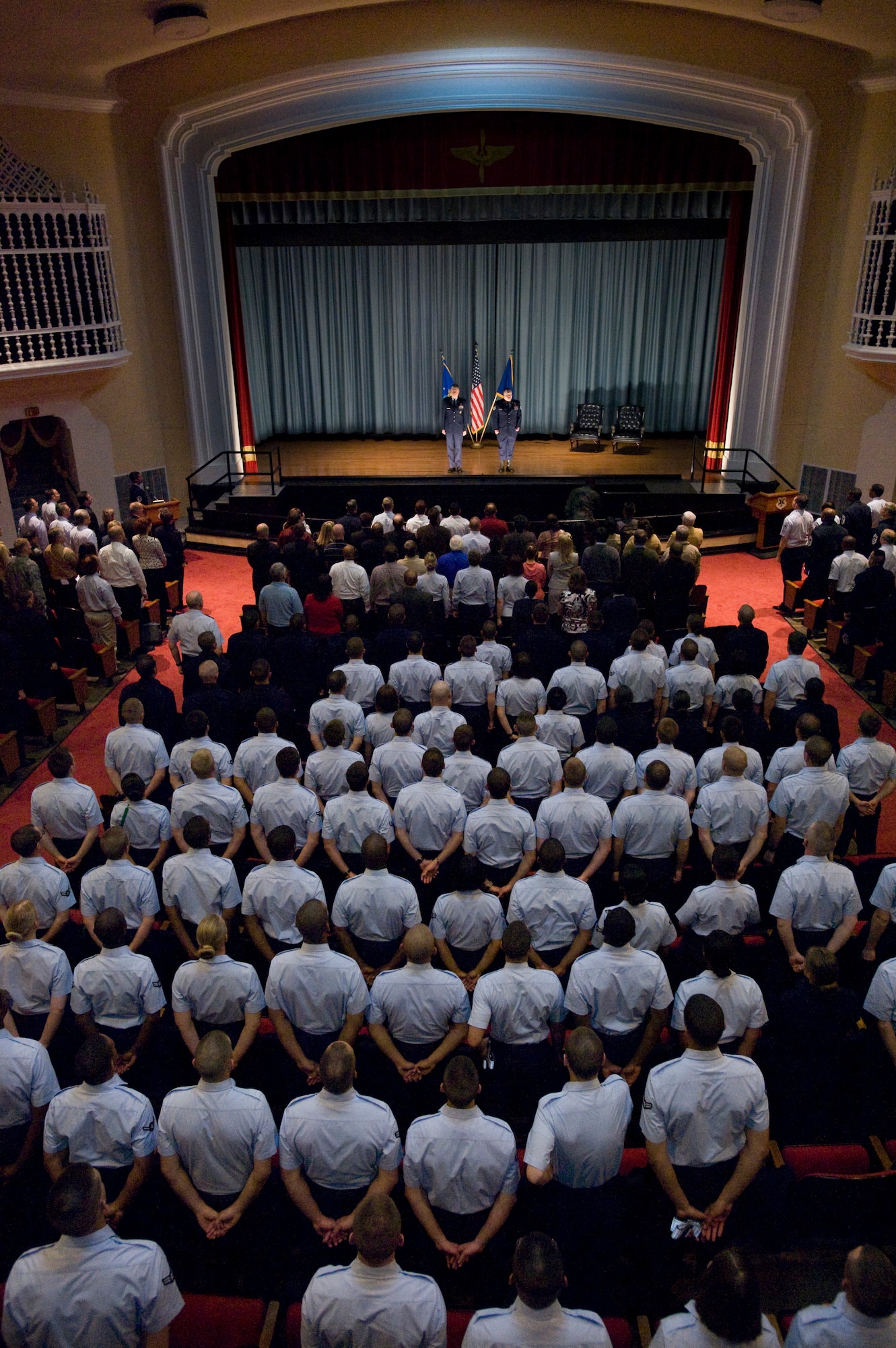 Maj. Gen. Anthony Przybyslawski, Air Education and Training Command vice commander, prepares to administer the oath of enlistment to Tech. Sgt. Israel Del Toro in a nearly-packed base theater here Feb. 8. Sergeant Del Toro suffered burns to more than 80 percent of his body after his vehicle rolled over an improvised explosive device and exploded in Afghanistan. (U.S. Air Force photo/Steve Thurow)