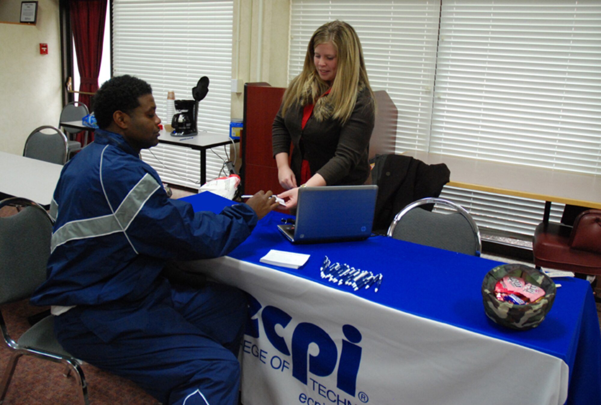 Master Sgt. Tony Smith, crew chief, 94th Maintenance Squadron, receives literature and contact information from military relations specialist for ECPI College of Technology at the 2010 Education fair at Verhulst Hall here Feb. 6-7. The event was designed to give Airmen the opportunity to speak with experts regarding classroom and online courses, G.I. Bill, military tuition assistance, financial aid and the college application process. (U.S. Air Force photo/Tech. Sgt. James Branch)