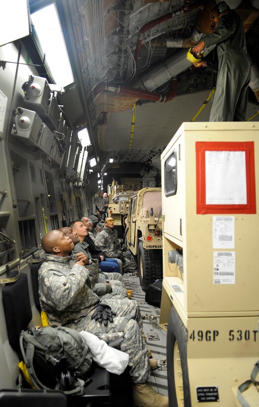 LANGLEY AIR FORCE BASE, Va. - Personnel from Fort Lee, Va. sit aboard a C-17 Globemaster III and receiving an in flight briefing Feb. 8.  Through a joint effort by Fort Eustis and Langley Air Force Base, personnel and cargo are being transported to Haiti as part of Operation Unified Response, a massive relief effort to aid the devastated country. (U.S. Air Force Photo/Senior Airman Dana Hill)