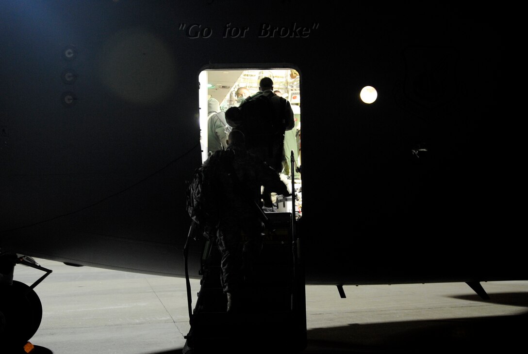 LANGLEY AIR FORCE BASE, Va. - Personnel from Fort Lee, Va. prepare to load onto a C-17 Globemaster III Feb. 8 through a joint effort by Fort Eustis and Langley Air Force Base. The personnel and cargo are being transported to Haiti as part of Operation Unified Response, a massive relief effort to aid the devastated country. (U.S. Air Force Photo/Senior Airman Dana Hill)