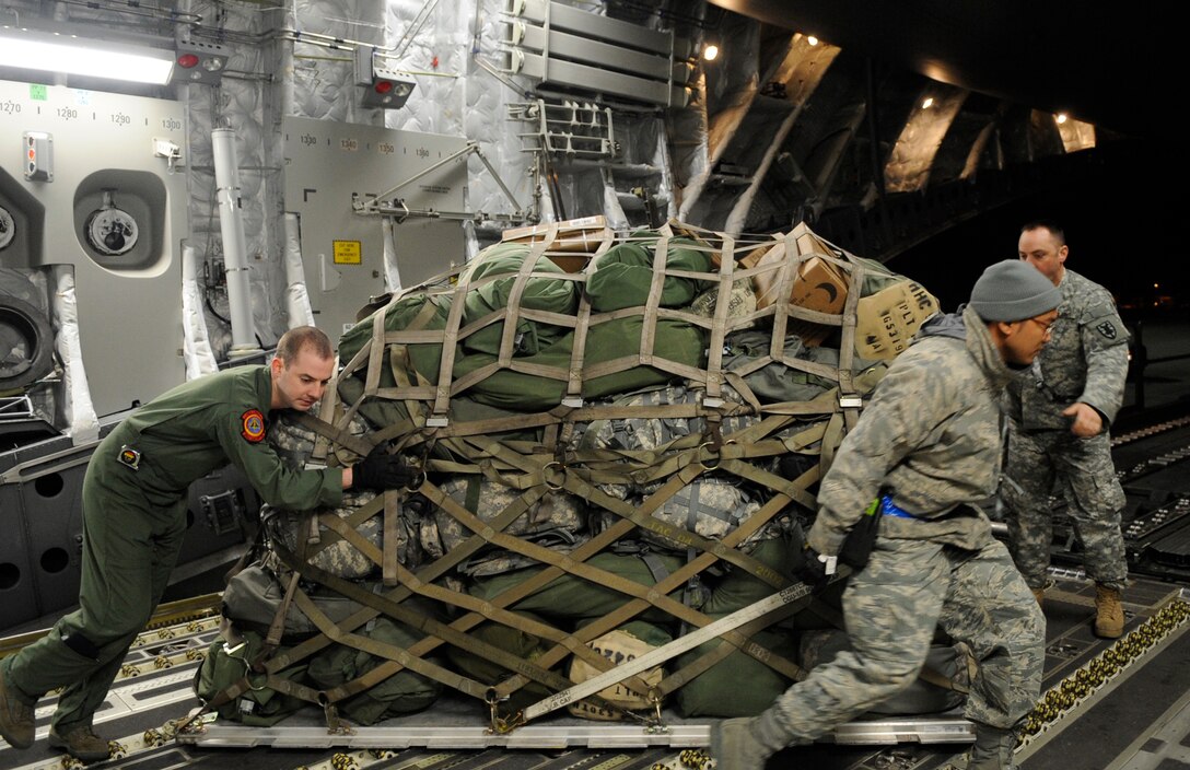 LANGLEY AIR FORCE BASE, Va. - Personnel and cargo from Fort Lee, Va. is prepared and loaded onto a C-17 Globemaster III Feb. 8 through a joint effort by Fort Eustis and Langley Air Force Base. The personnel and cargo are being transported to Haiti as part of Operation Unified Response, a massive relief effort to aid the devastated country. (U.S. Air Force Photo/Senior Airman Dana Hill)