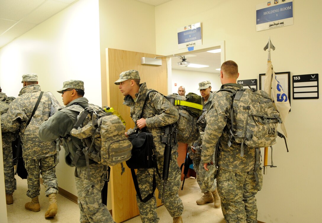 LANGLEY AIR FORCE BASE, Va. - Personnel from Fort Lee, Va. prepare to load onto a C-17 Globemaster III Feb. 8 through a joint effort by Fort Eustis and Langley Air Force Base. The personnel and cargo are being transported to Haiti as part of Operation Unified Response, a massive relief effort to aid the devastated country. (U.S. Air Force Photo/Senior Airman Dana Hill)