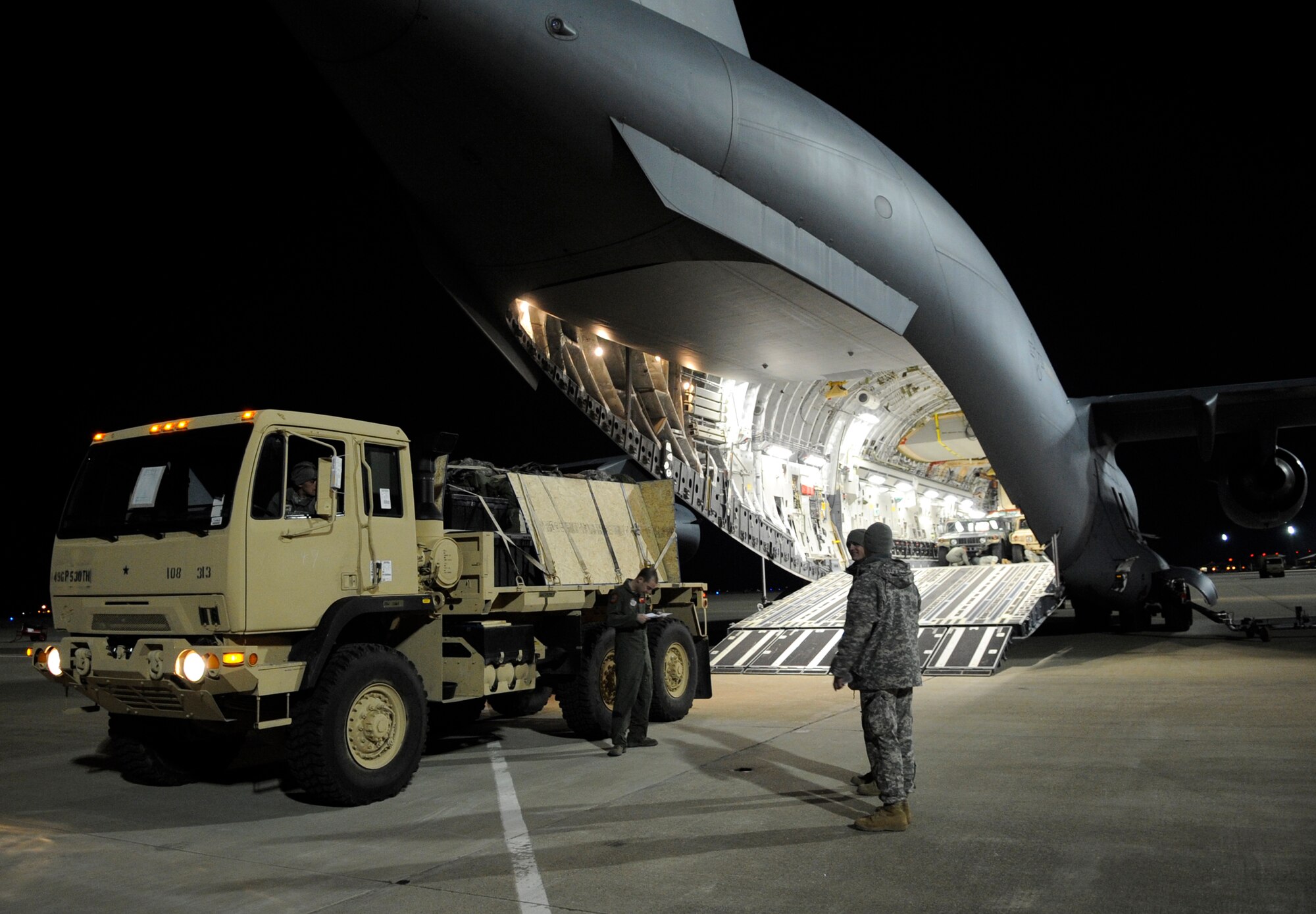 LANGLEY AIR FORCE BASE, Va. - Personnel and cargo from Fort Lee, Va. is prepared and loaded onto a C-17 Globemaster III Feb. 8 through a joint effort by Fort Eustis and Langley Air Force Base. The personnel and cargo are being transported to Haiti as part of Operation Unified Response, a massive relief effort to aid the devastated country. (U.S. Air Force Photo/Senior Airman Dana Hill)