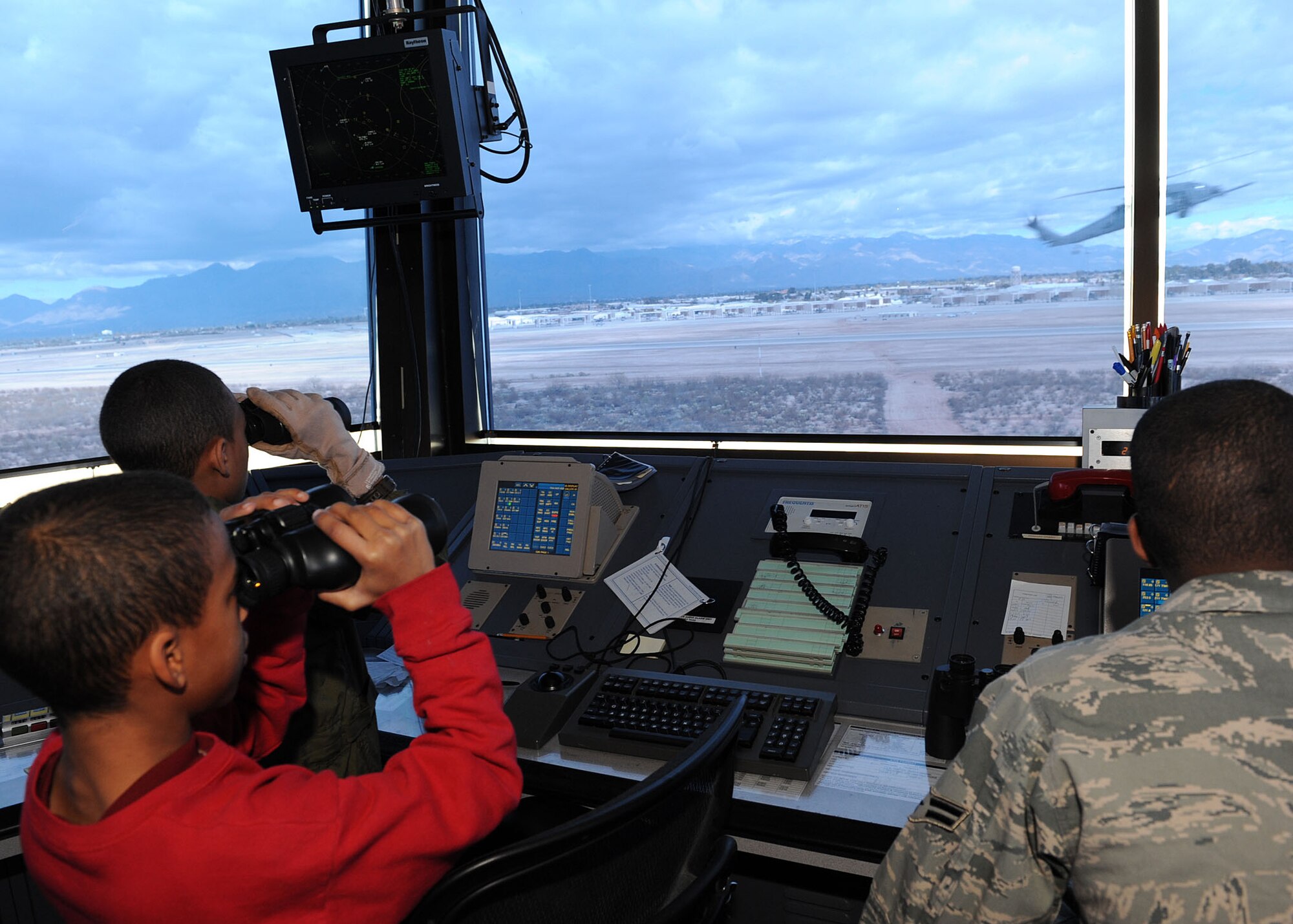 Markino Mctaggrait and Alex Rodriguez watch as an HH-60 flies in front of the air traffic tower during the Pilot for a Day program here Jan. 29. This program is designed for children with serious illnesses and helps them enjoy a day totally devoted to them and their interest in aviation. Markino had a chance to fly in an A-10 simulator, see the base's fire department, aircraft static displays and meet members of the U.S. Air Force. Maj. James Miller, an A-10 instructor pilot assigned to the 355th
Training Squadron served as the day's host pilot. (U.S. Air Force/Staff Sgt. Jacqueline Romero)
