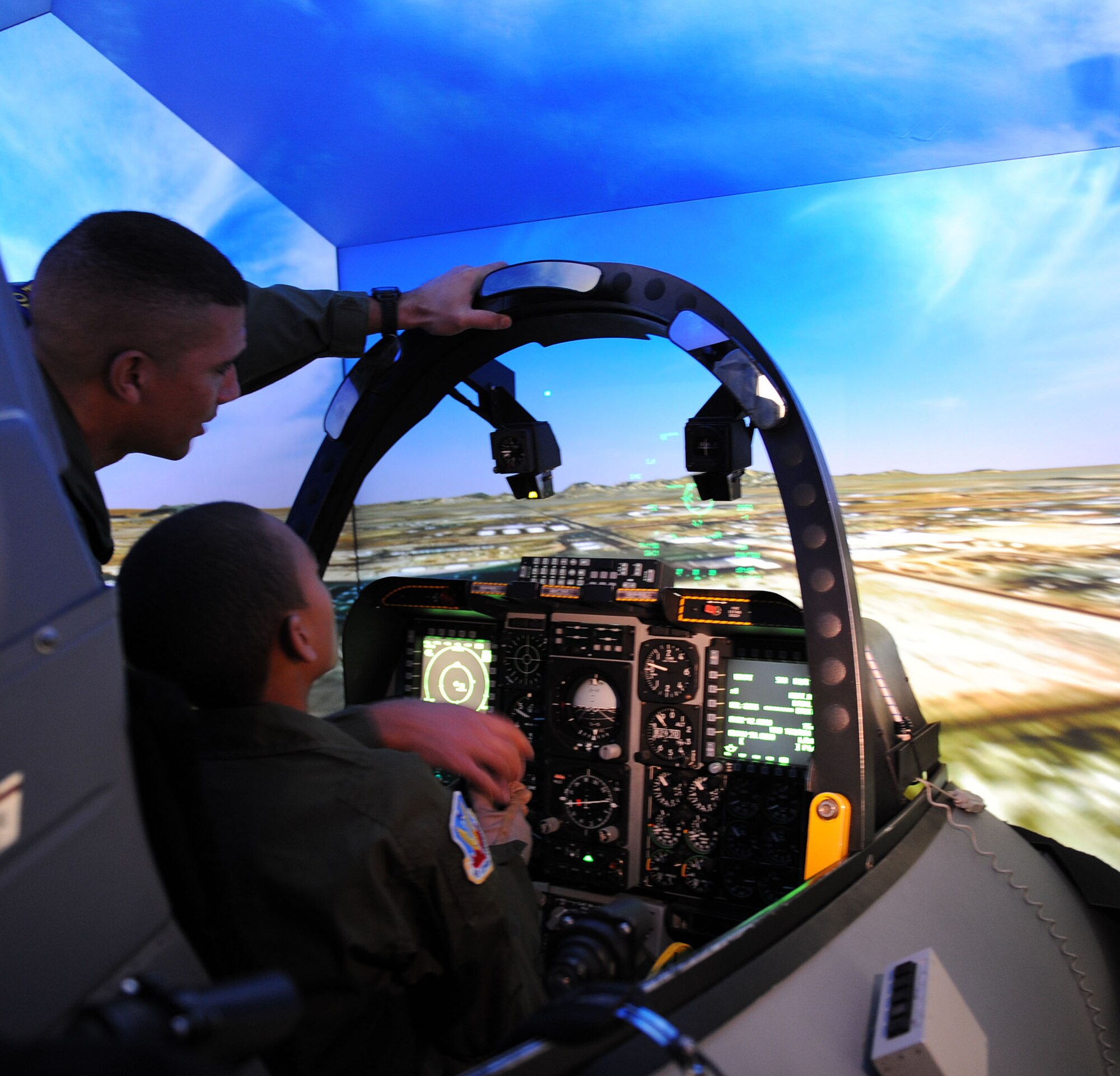 Maj. James Miller, an A-10 instructor pilot assigned to the 355th Training Squadron, helps Markino Mctaggrait fly the A-10 simulator during the Pilot for a Day program here Jan. 29. This program is designed for children with serious illnesses and helps them enjoy a day totally devoted to them and their interest in aviation. Markino had a chance to fly in an A-10 simulator, see the base's fire department, aircraft static displays and meet members of the U.S. Air Force. Major Miller was the day's host pilot. (U.S. Air Force/Staff Sgt. Jacqueline Romero)
