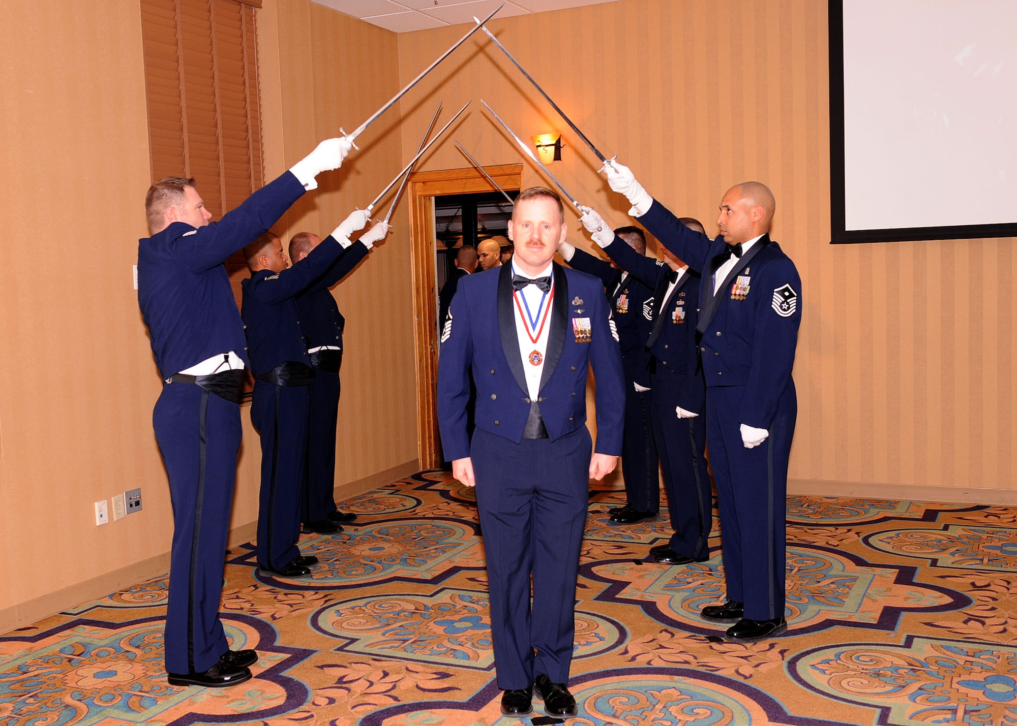 Master Sgt. Brent Consbruck, 355th Mission Support Group nominee for first sergeant of the year, enters the room at the beginning of Operation Excellence "Best of the Best 2009" at the Mirage Club here Jan. 30. The event recognized 83 nominees in nine categories. (U.S. Air Force photo/Senior Airman Jacqueline Romero)
