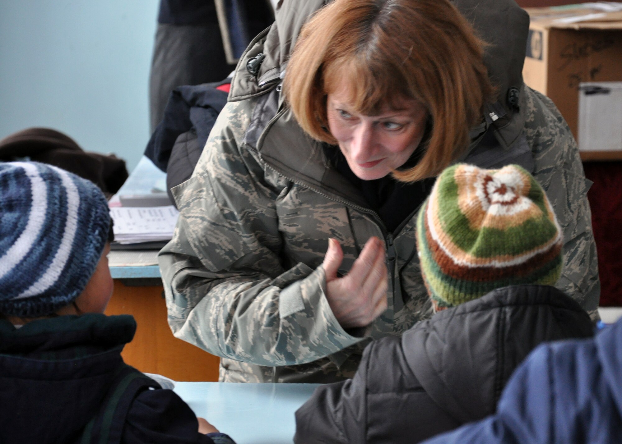 Maj. Gen. Polly Peyer, Commander, Warner Robins Air Logistics Center, Air Force Materiel Command, Robins Air Force Base, Ga., introduces herself to girls from Grozd School in Grozd Village, Kyrgyzstan, Feb. 9. She and other general officers visited the school to hand out warm clothing and goodies during their visit to Kyrgyzstan. (U.S. Air Force photo/Staff Sgt. Carolyn Viss/released)