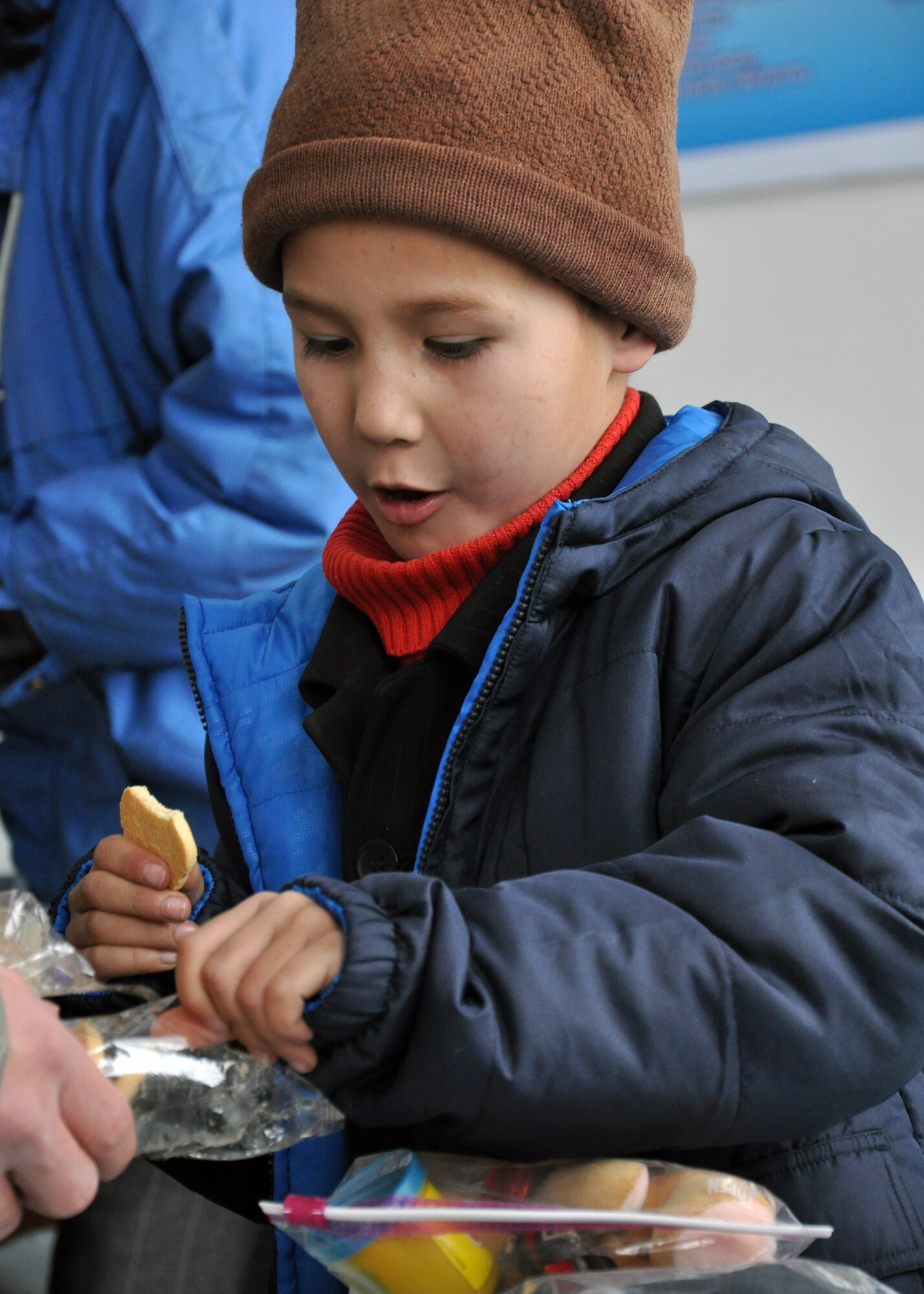 An elementary school boy from Grozd School in Grozd Village, Kyrgyzstan, is glad to receive warm clothing, snacks and other items from Airmen from the Transit Center at Manas Feb. 9, 2010. (U.S. Air Force photo/Staff Sgt. Carolyn Viss/released) 
