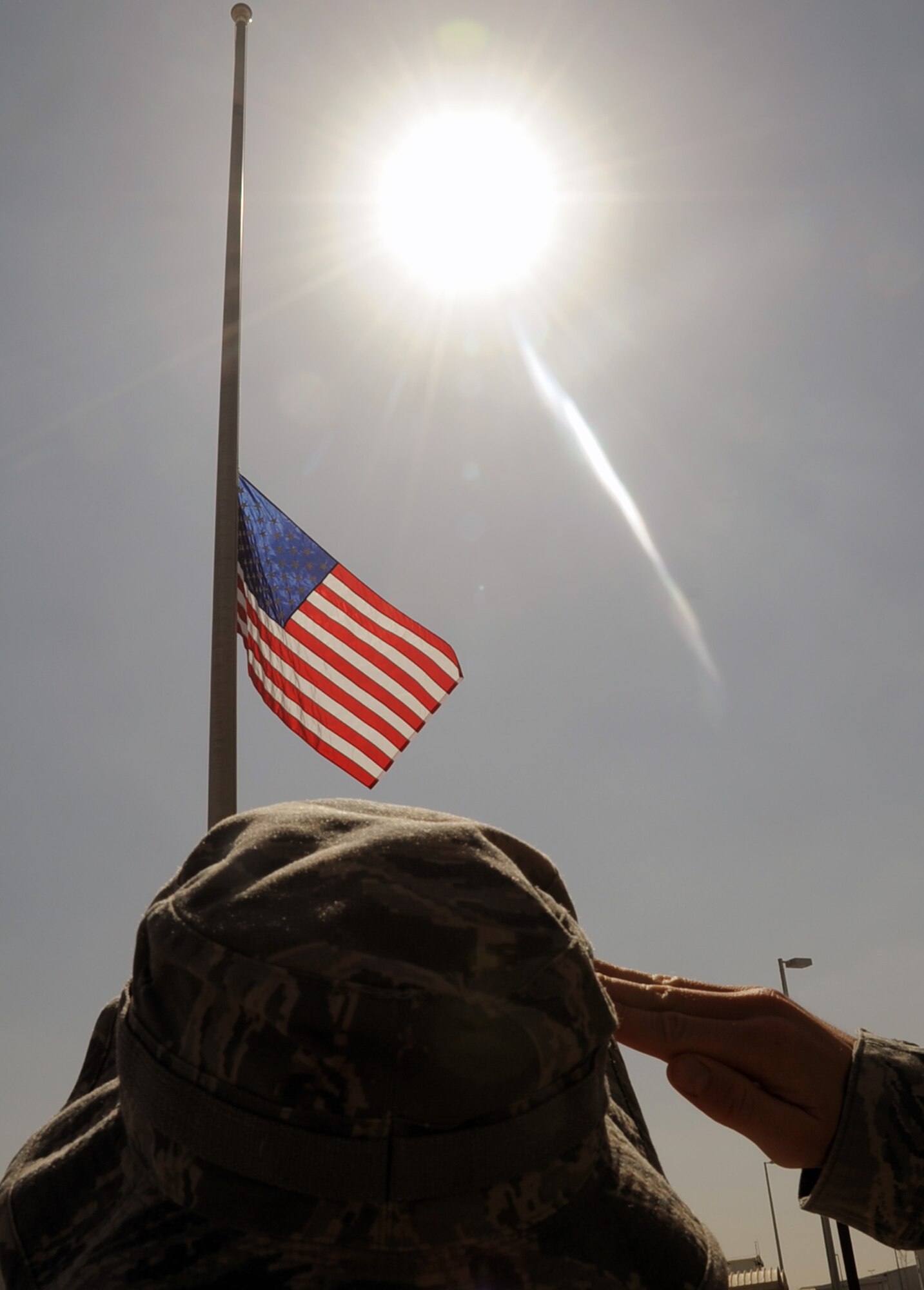 An Airman assigned to the 380th Air Expeditionary Wing at a non-disclosed base in Southwest Asia salutes the American flag Feb. 9, 2010, that is flying at half-mast in honor of U.S. Representive John Murtha of Pennsywho died on Feb. 8. Representative Murtha was a military veteran who earned the Bronze Star and two Purple Hearts during the Vietnam War. Military installations around the world flew the flag at half-mast Feb. 9 in honor of Representative Murtha by declaration from President Barack Obama. (U.S. Air Force Photo/Master Sgt. Scott T. Sturkol/Released)