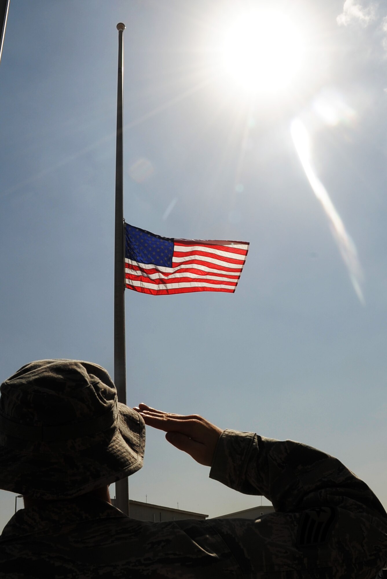 An Airman assigned to the 380th Air Expeditionary Wing at a non-disclosed base in Southwest Asia salutes the American flag Feb. 9, 2010, that is flying at half-mast in honor of U.S. Representive John Murtha of Pennsywho died on Feb. 8. Representative Murtha was a military veteran who earned the Bronze Star and two Purple Hearts during the Vietnam War. Military installations around the world flew the flag at half-mast Feb. 9 in honor of Representative Murtha by declaration from President Barack Obama. (U.S. Air Force Photo/Master Sgt. Scott T. Sturkol/Released)