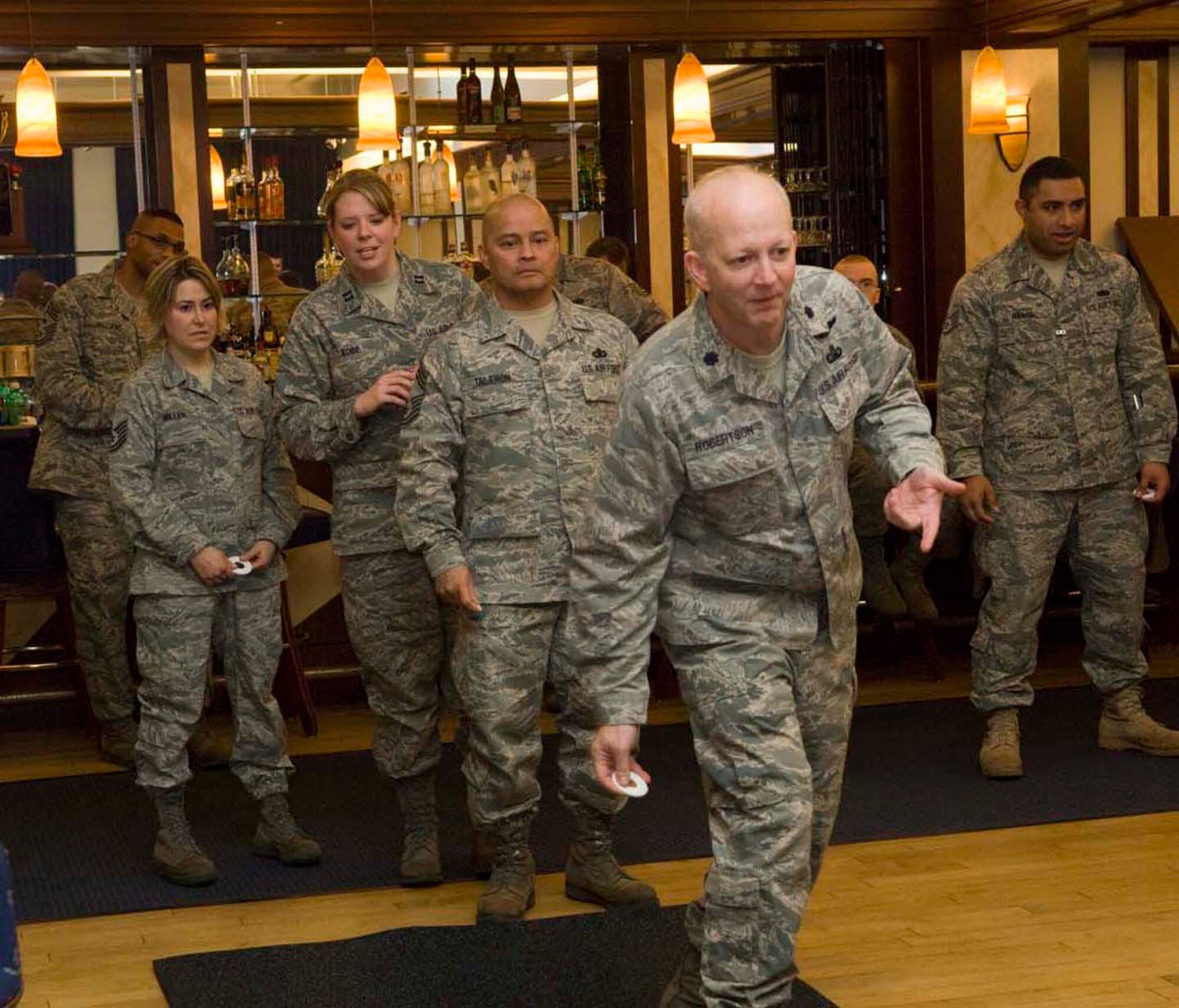 HANSCOM AIR FORCE BASE, Mass. – 66th Mission Support Group deputy  commander  Lt. Col. Randy Robertson makes his pitch as team “Boston Three Party plus one” take their turn at the 66 Air Base Wing  Washers Tournament (Jan. 28) held at the Minuteman Club.   Watching closely are team members Capt. Jessica Kobe, Chief Master Sgt. Glenn Taijeron, Tech. Sgt. Glenna Miller. (U.S. Air Force photo by Rick Berry)