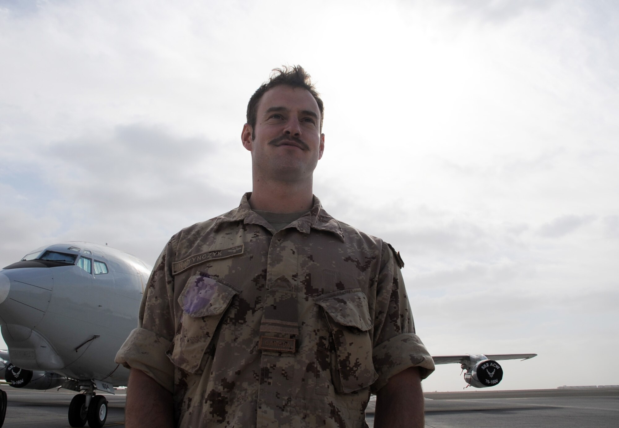Canadian Forces Lt. Will Natynczyk stands near an E-3 Sentry Airborne Warning and Control System aircraft at a non-disclosed base in Southwest Asia on Jan. 28, 2010. Lieutenant Natynczyk is one of five Canadian Forces members deployed with the 965th Expeditionary Airborne Air Control Squadron.  The six-and-a-half-year Canadian Forces veteran is an air weapons officer for the E-3 Sentry.  The lieutenant is deployed from Tinker Air Force Base, Okla., and his hometown is Ottawa, Ontario, Canada.  (U.S. Air Force Photo/Master Sgt. Scott T. Sturkol/Released)