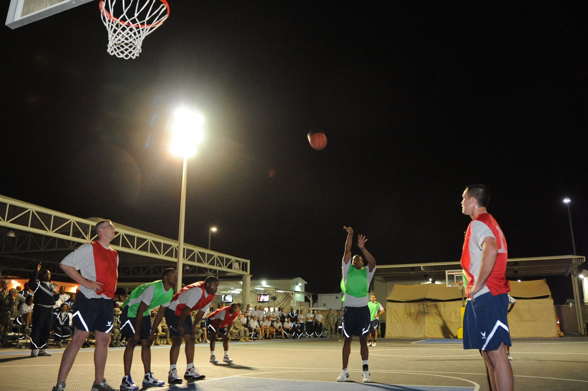 A member of 380th Expeditionary Civil Engineer Squadron attempts to make a shot during the intramural basketball championshiop game against the 380th Expeditionary Security Forces Squadron at undisclosed location in Southwest Asia on Feb. 5, 2010. ECES won the game 30 to 24.(U.S. Air Force photo/Senior Airman Jenifer H. Calhoun/Released)
