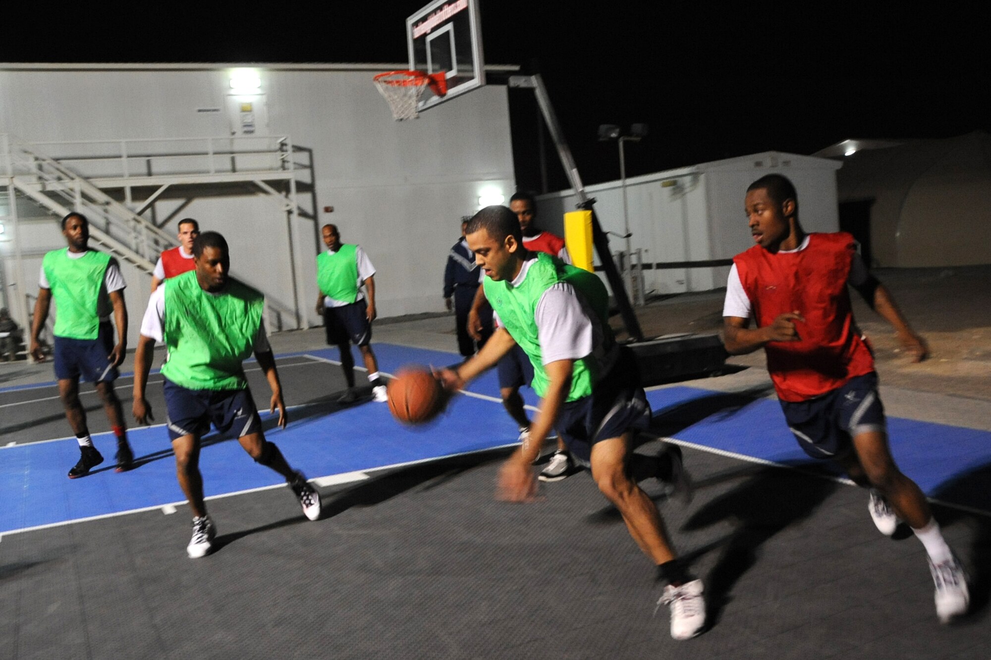 A member of 380th Expeditionary Civil Engineer Squadron dribbles the ball during the intramural basketball championshiop game against the 380th Expeditionary Security Forces Squadron at undisclosed location in Southwest Asia on Feb. 5, 2010. ECES won the game 30 to 24.(U.S. Air Force photo/Senior Airman Jenifer H. Calhoun/Released)
