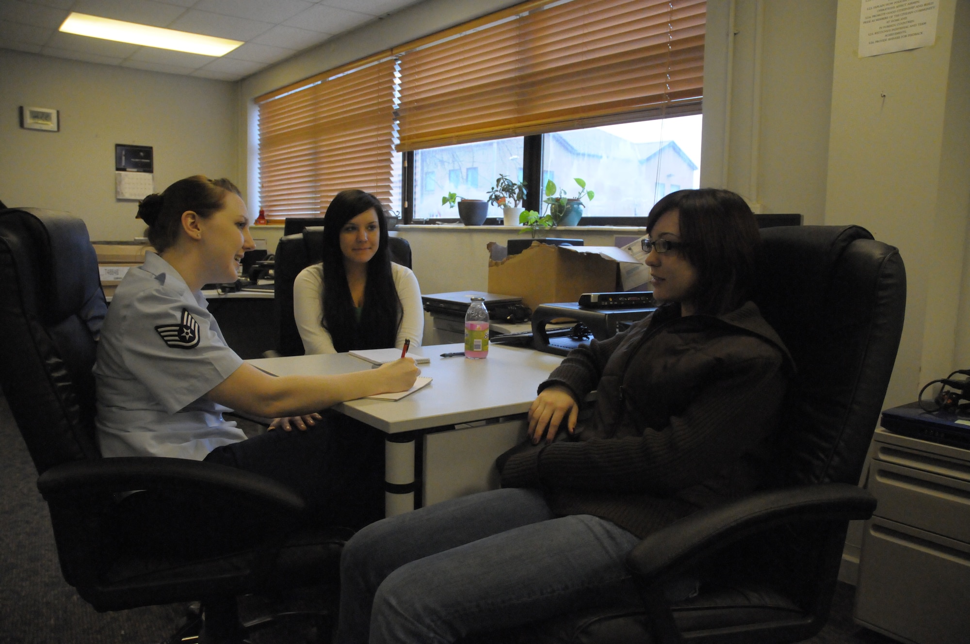 Staff Sgt. Megan Lyon, 48th Fighter Wing Public Affairs NCO in charge of community relations, talks about her career field to Raven Ashton (middle) and Jamie Vittore, two students from Lakenheath High School during Job Shadow Day at RAF Lakenheath, England, Feb. 8.  Job Shadow Day introduces students to a variety of professions and industries and helps them prepare to join the workforce later in life.   (U.S. Air Force photo by Staff Sgt. Connor Estes)