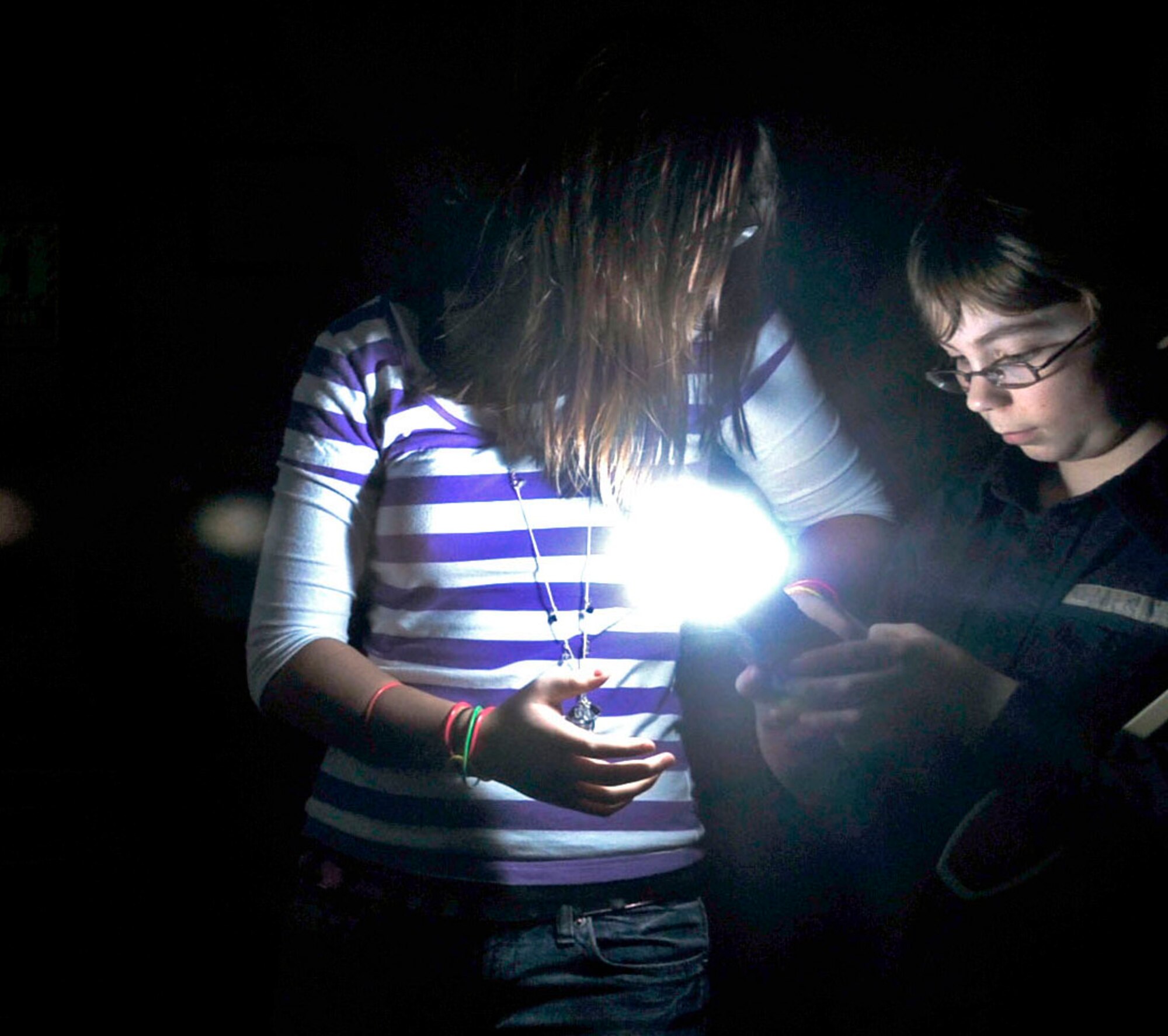 Feltwell Middle School students Clarissa Wood and Alexander Campbell prepare a camera flash meter in the 48th Fighter Wing Public Affairs office’s photo studio during Job Shadow Day at RAF Lakenheath, England, Feb. 8.  Job Shadow Day demonstrates a connection between education and careers and tries to inspire students to work hard in school to achieve future career aspirations.   (U.S. Air Force photo by Staff Sgt. Connor Estes)