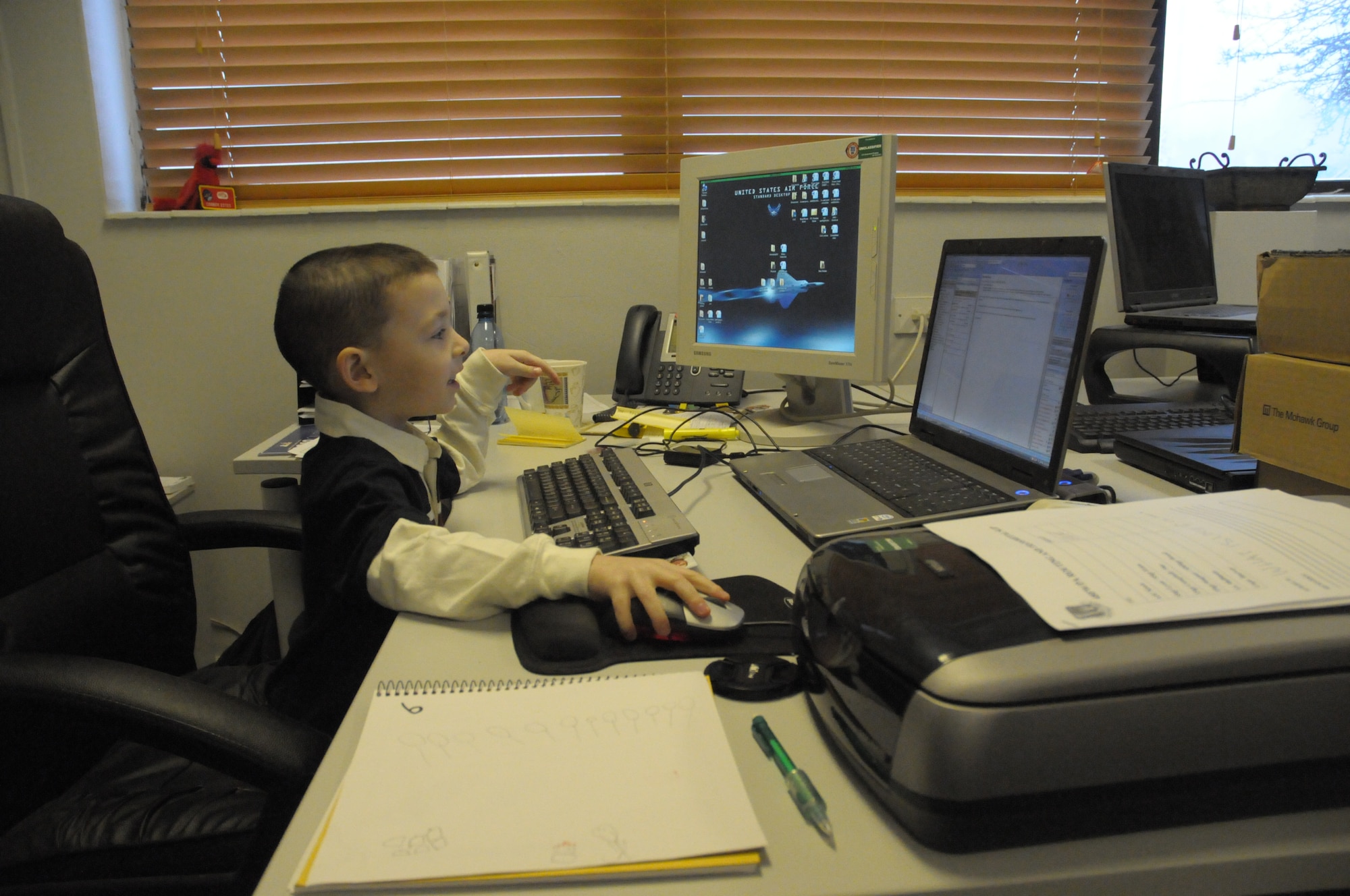 Feltwell Elementary School student Tristan Estes, age 5, looks over his father’s work on Job Shadow Day at RAF Lakenheath, England, Feb. 8.  Job Shadow Day is formally known as "bring your child to work day” and allows children to see what their parents do while at work and its importance to the Air Force mission. (U.S. Air Force photo by Staff Sgt. Connor Estes)