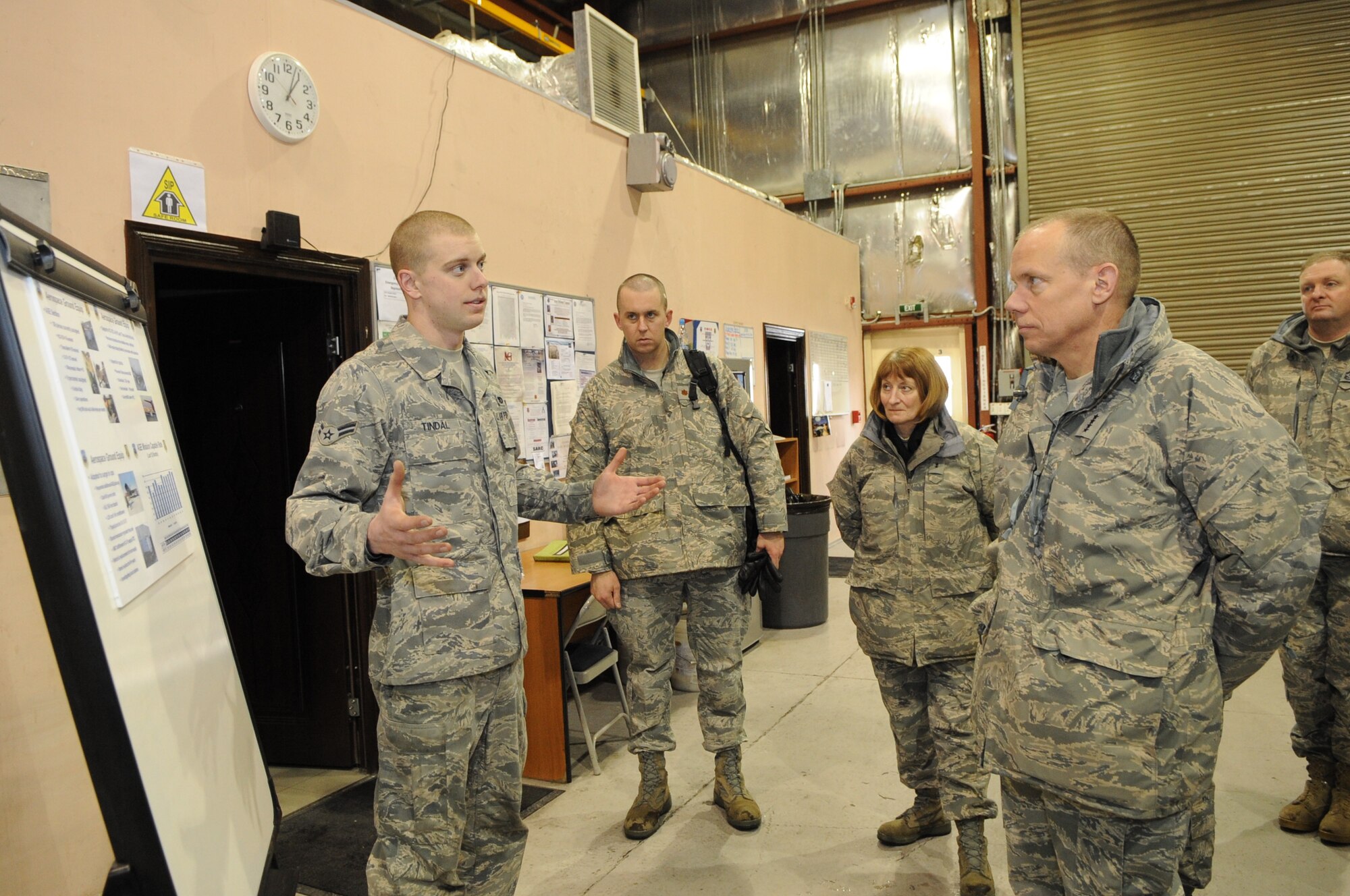 Airman 1st Class Mitch Tindal briefs Gen. Donald Hoffman, Commander of Air Force Materiel Command, on aerospace ground equipment at the Transit Center at Manas, Kyrgyzstan, Feb. 7, 2010. General Hoffman visited the Transit Center as part of a trip through the U.S. Central Command?s area of responsibility to acquire feedback directly from the warfighter about the test and sustainment support AFMC is contributing to the fight. Airman Tindal works in the 376th Expeditionary Aircraft Maintenance Squadron AGE section. (U.S. Air Force photo/Senior Airman Nichelle Anderson/released)
