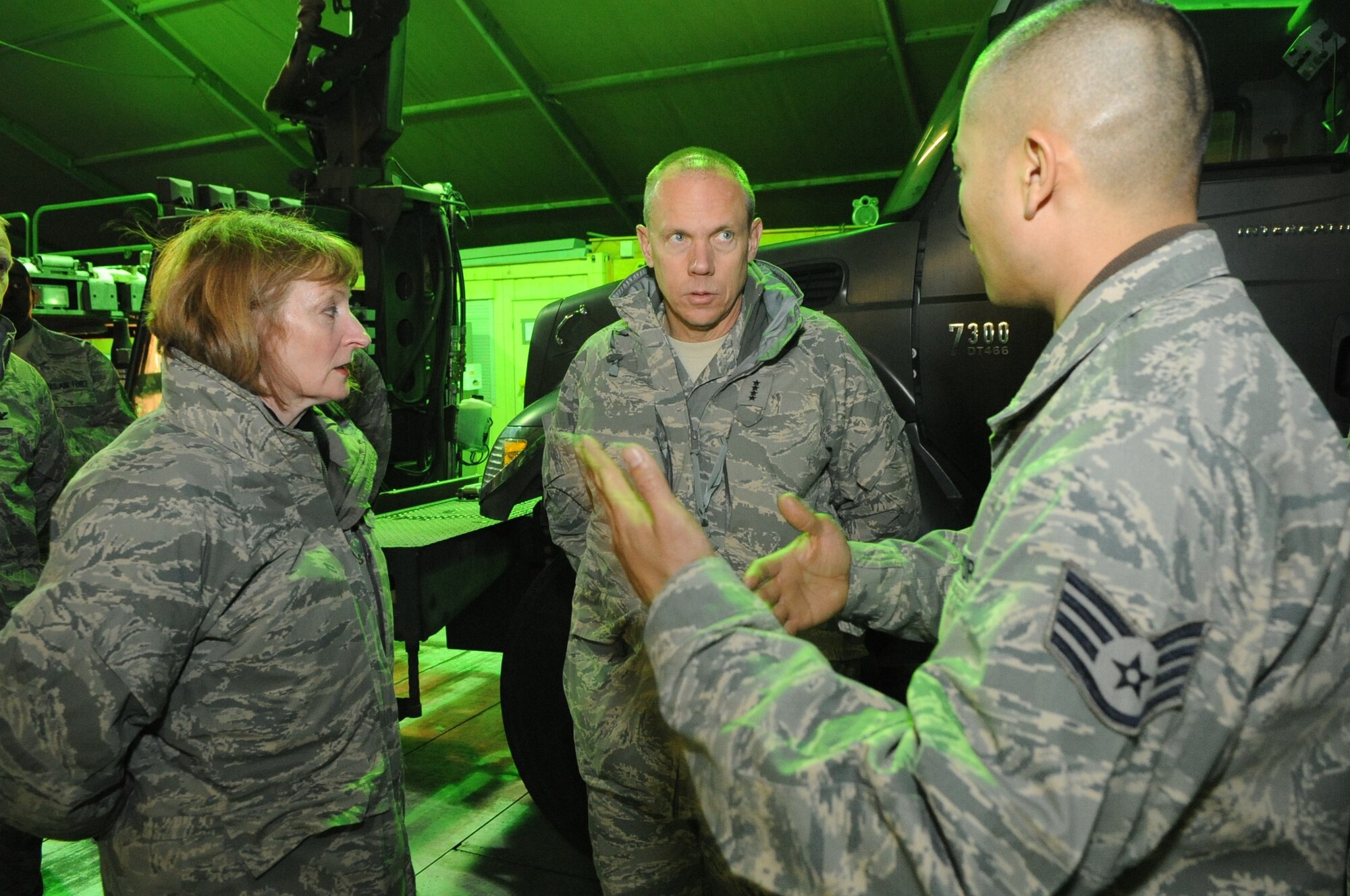 Gen. Donald Hoffman, Commander of Air Force Materiel Command, and Maj. Gen. Polly Peyer Commander Warner Robins Air Logistics Center, Air Force Material Command, Robins Air Force Base, Ga., speak with Staff Sgt. Allan Lee about the role of vehicle maintenance at the Transit Center at Manas, Kyrgyzstan, Feb. 7, 2010. General Hoffman and General Peyer visited the Transit Center as part of a trip through the U.S. Central Command?s area of responsibility to acquire feedback directly from the warfighter about the test and sustainment support AFMC is contributing to the fight.  Sergeant Lee works in the 376th Expeditionary Logistics Readiness Squadron Vehicle Management section. (U.S. Air Force photo/Senior Airman Nichelle Anderson/released)