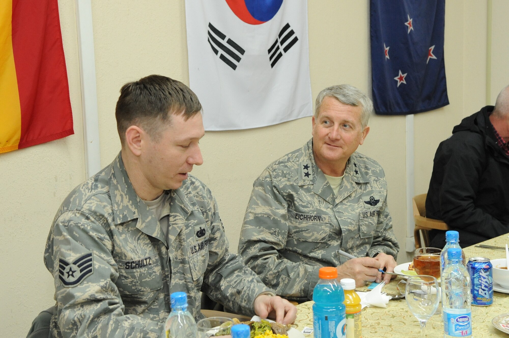 Maj. Gen. David Eichhorn, Commander of the Air Flight Test Center, Edwards Air Force Base, Calif., speaks with Airmen over dinner at the Transit Center at Manas, Kyrgyzstan, Feb. 6, 2010. General Eichhorn visited the Transit Center as part of a trip through the U.S. Central Command?s area of responsibility to acquire feedback directly from the warfighter about the test and sustainment support Air Force Materiel Command is contributing to the fight.  (U.S. Air Force photo/Senior Airman Nichelle Anderson/released)