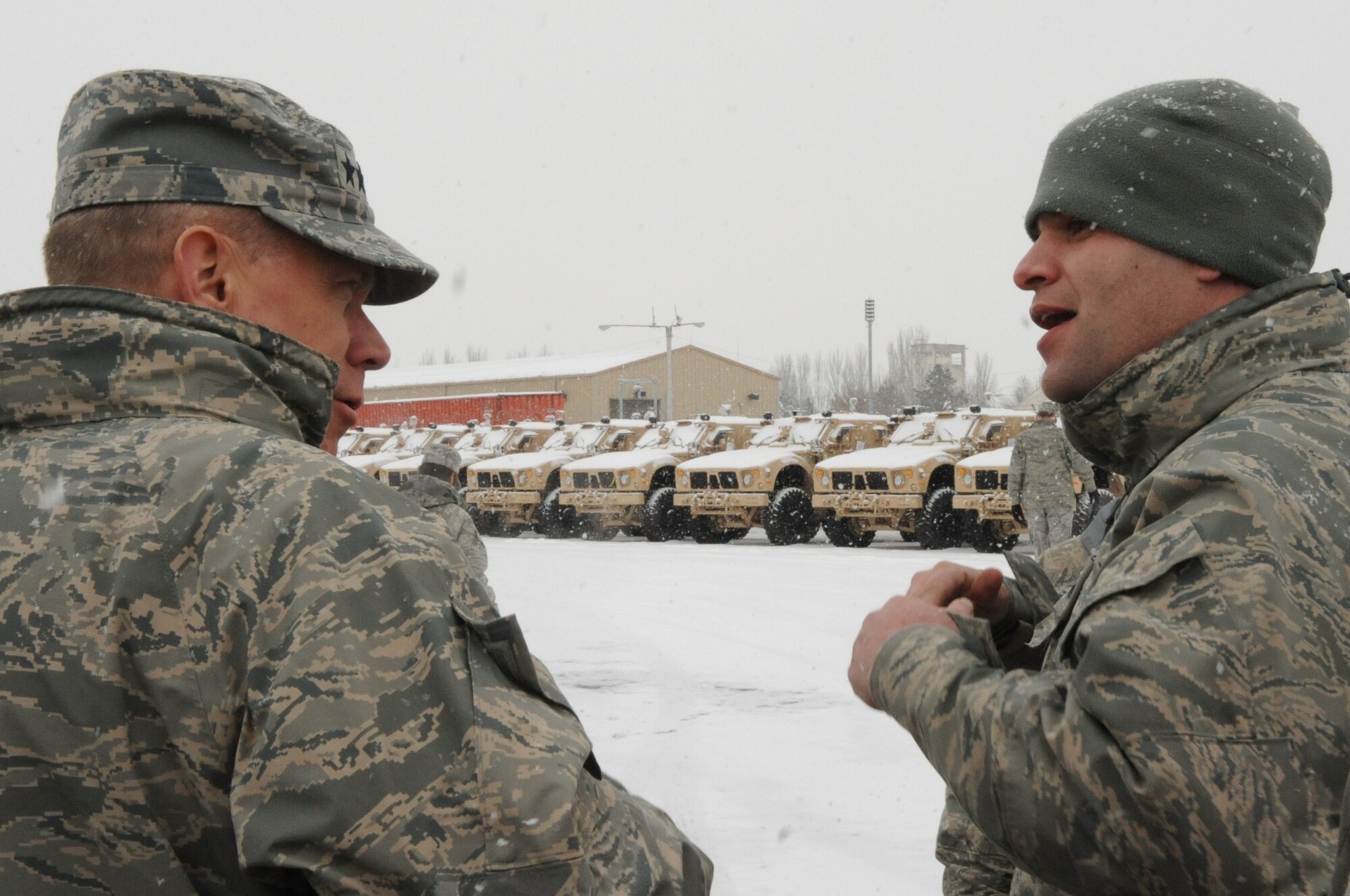 U.S. Air Force Tech. Sgt. Matthew Sollars, 376th Expeditionary Logistics Readiness Squadron aerial porter, briefs Gen. Donald Hoffman, Commander of Air Force Materiel Command, on the mission of the Transit Center at Manas , Kyrgyzstan, Feb. 7, 2010, in relation to the MRAP all-terrain vehicles that are being transported to Marines downrange. General Hoffman, visited the Transit Center as part of a trip through the U.S. Central Command’s area of responsibility to acquire feedback directly from the warfighter about the test and sustainment support AFMC is contributing to the fight. (U.S. Air Force photo/Staff Sgt. Carolyn Viss/released)