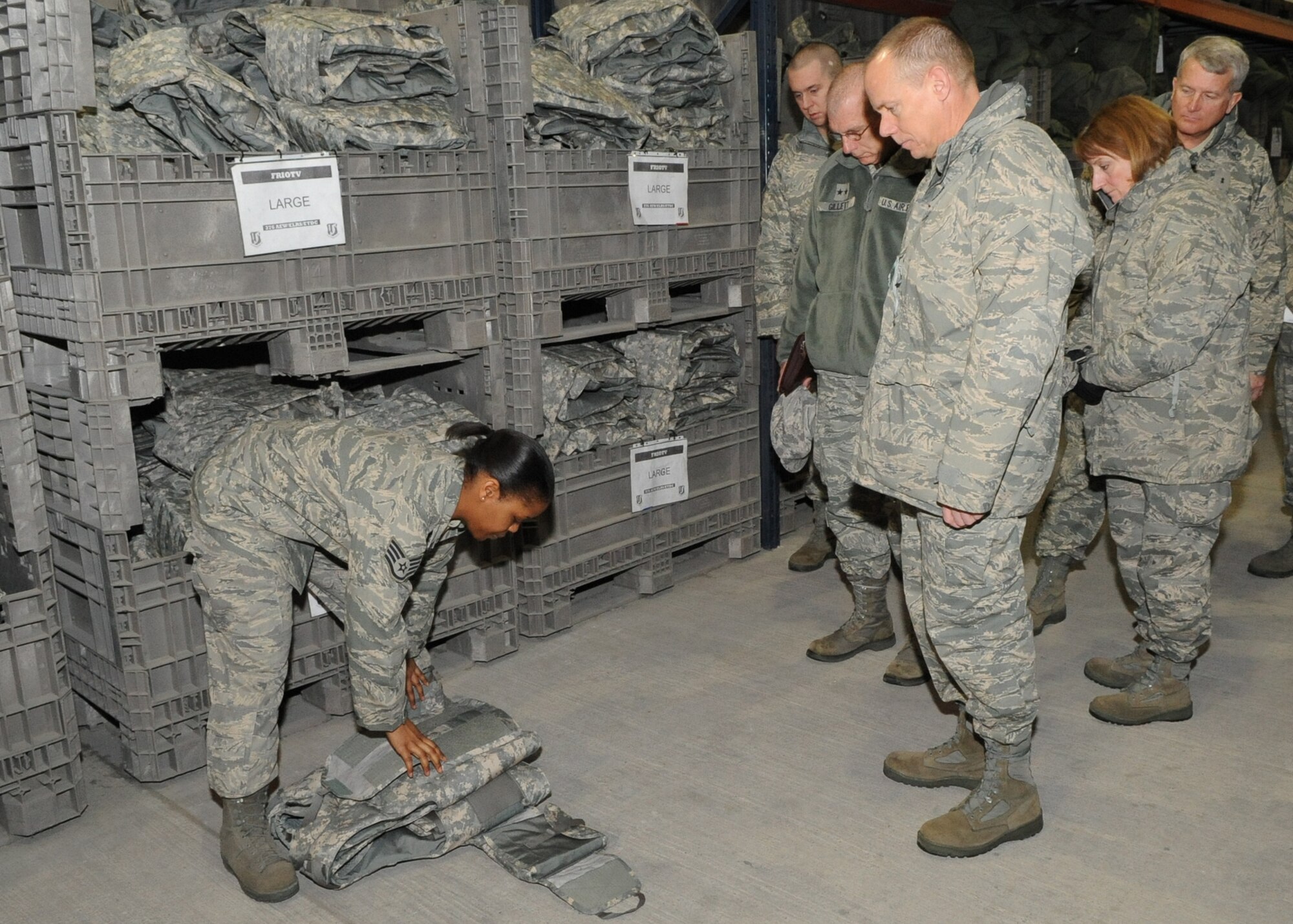 U.S. Air Force Staff Sgt. Cleo Briscoe shows Gen. Donald Hoffman, Commander of Air Force Materiel Command, an improved outer tactical vest during his visit to the Transit Center at Manas, Kyrgyzstan, Feb. 7, 2010, as part of a trip through the U.S. Central Command’s area of responsibility. General Hoffman is making this trip to acquire feedback directly from the warfighter about the test and sustainment support AFMC is contributing to the fight. Sergeant Briscoe works in the 376th Expeditionary Logistics Readiness Squadron Expeditionary Theater Distribution Center. (U.S. Air Force photo/Staff Sgt. Carolyn Viss/released)
