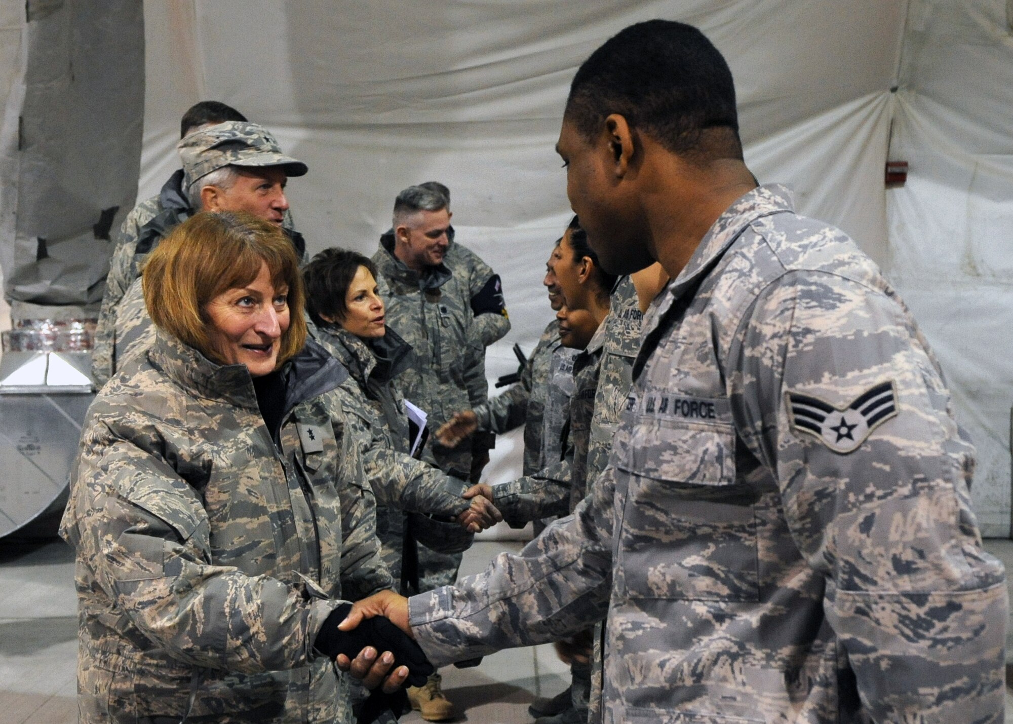 Maj. Gen. Polly Peyer, Commander, Warner Robins Air Logistics Center, Air Force Materiel Command, Robins Air Force Base, Ga., greets 376th Expeditionary Logistics Readiness Squadron Expeditionary Theater Distribution Center Airmen at the Transit Center at Manas, Kyrgyzstan, Feb. 7, 2010. General Peyer visited the Transit Center as part of a trip through the U.S. Central Command’s area of responsibility to acquire feedback directly from the warfighter about the test and sustainment support AFMC is contributing to the fight. (U.S. Air Force photo/Staff Sgt. Carolyn Viss/released) 