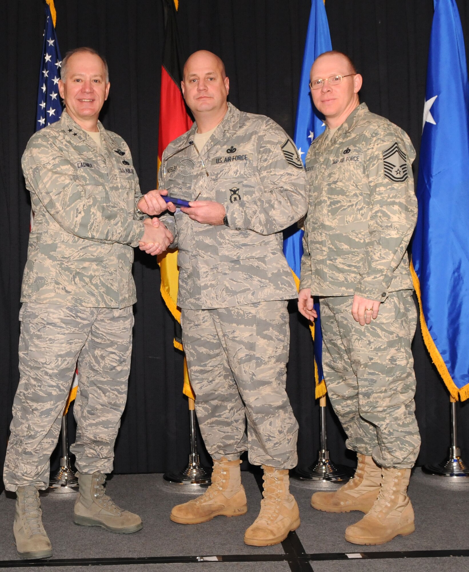 Maj. Gen. Ronald Ladnier, 17th Air Force Commander (left), and Chief Master Sgt. Steven Scott, acting 17th AF Command Chief (right), present the 2009 SNCO of the Year award to Master Sgt. Michael Keeler, (A4/7) during the annual awards breakfast Feb. 9.
