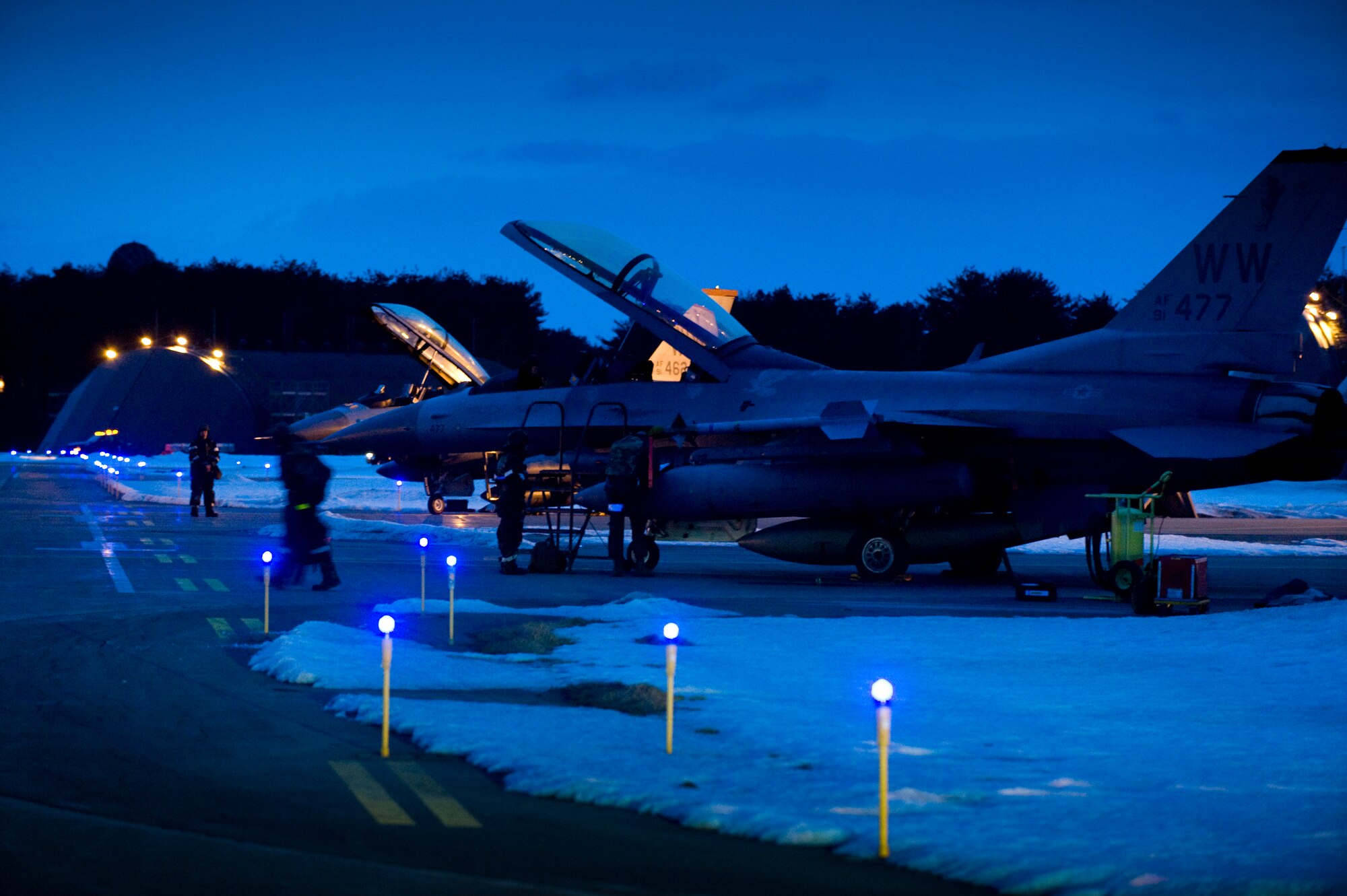 MISAWA AIR BASE, Japan -- Maintenance crews ready two F-16 Fighting Falcons on the flightline for flight during an operational readiness exercise Feb. 1. These dual-seat models were used as aggressor aircraft to test pilots on how to evade or engage enemies. (U.S. Air Force photo/Staff Sgt. Samuel Morse)