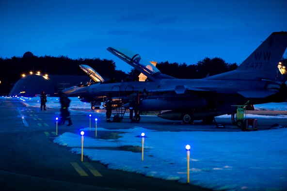 Maintenance crews ready two F-16 Fighting Falcons on the flightline for flight during an operational readiness exercise Feb. 1, 2010, at Misawa Air Base, Japan. These dual-seat models were used as aggressor aircraft to test pilots on how to evade or engage enemies. (U.S. Air Force photo/Staff Sgt. Samuel Morse) 