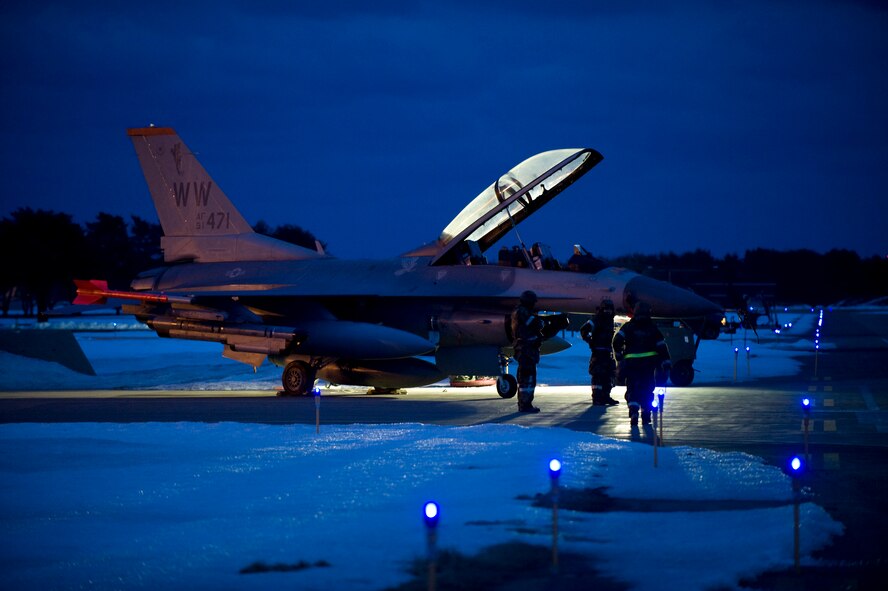 Maintenance crews ready an F-16 Fighting Falcon on the flightline for flight during an operational readiness exercise Feb. 1, 2010, at Misawa Air Base, Japan. After sundown, floodlights enable crews to keep working and continue operations into the night. (U.S. Air Force photo/Staff Sgt. Samuel Morse) 

