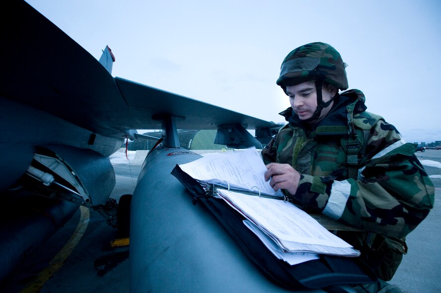 Staff Sgt. Michael Pratt, 14th Aircraft Maintenance Unit crewchief, reviews maintenance paperwork for an F-16 Fighting Falcon on the flightline during an operational readiness exercise Feb. 1, 2010, at Misawa Air Base, Japan. By keeping accurate documentation, Sergeant Pratt makes it possible for the next shift of crewchiefs to pick up where he left off. (U.S. Air Force photo/Staff Sgt. Samuel Morse) 